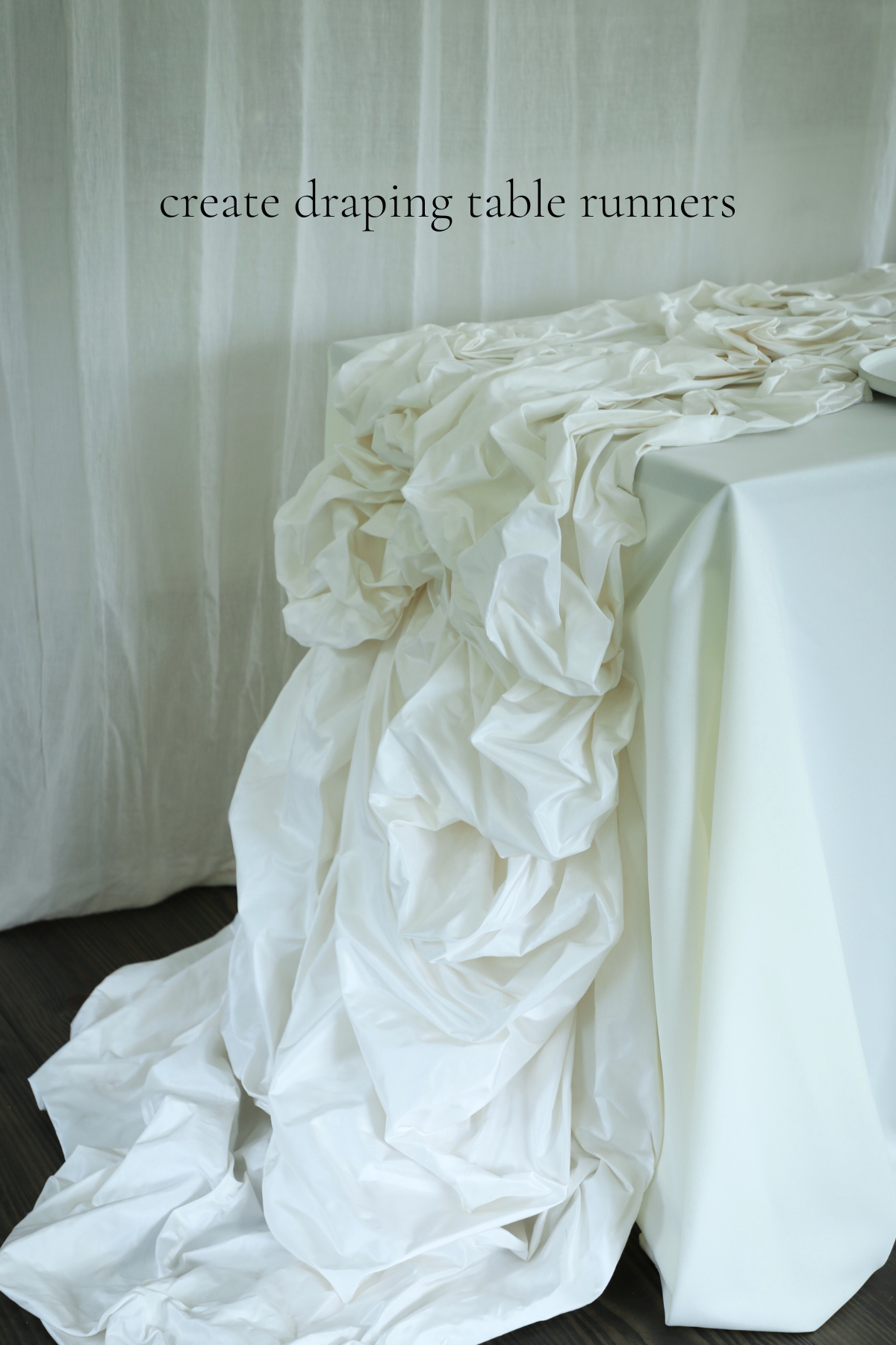 White floral table runner draped over a table with text 'create draping table runners' on a plain background.