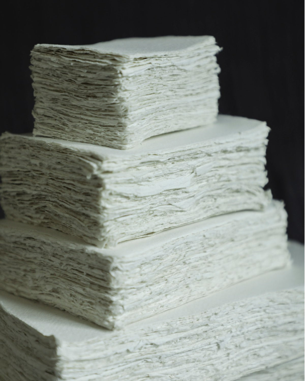 Stack of white paper sheets on a black background