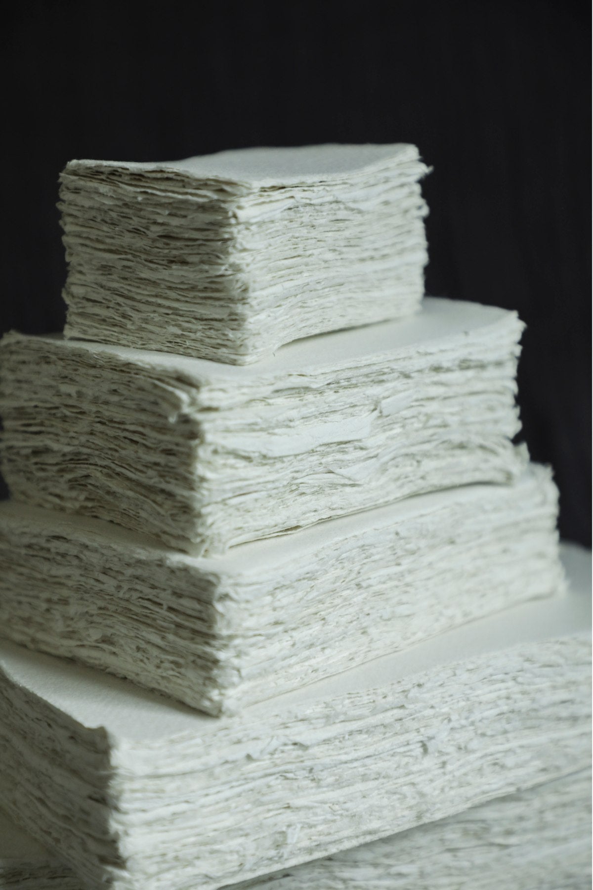 Stack of white paper sheets on a black background