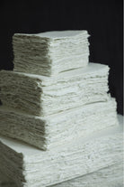 Stack of white paper sheets on a black background