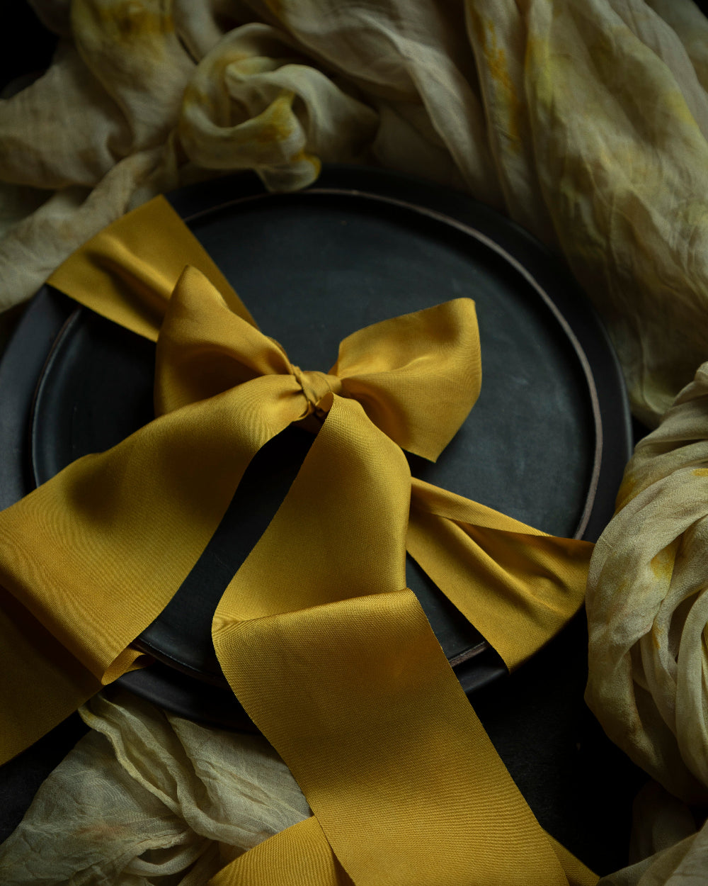 Gold plant-dyed silk ribbons not only elevate floral arrangements but also add a touch of elegance to wedding table decor elements. Their versatile nature allows for creative applications, from delicate bow ties on wedding favours to stunning drapery for table settings. Available in a range of organic colours inspired by nature, each ribbon offers a unique story, enhancing the overall aesthetic of the occasion.