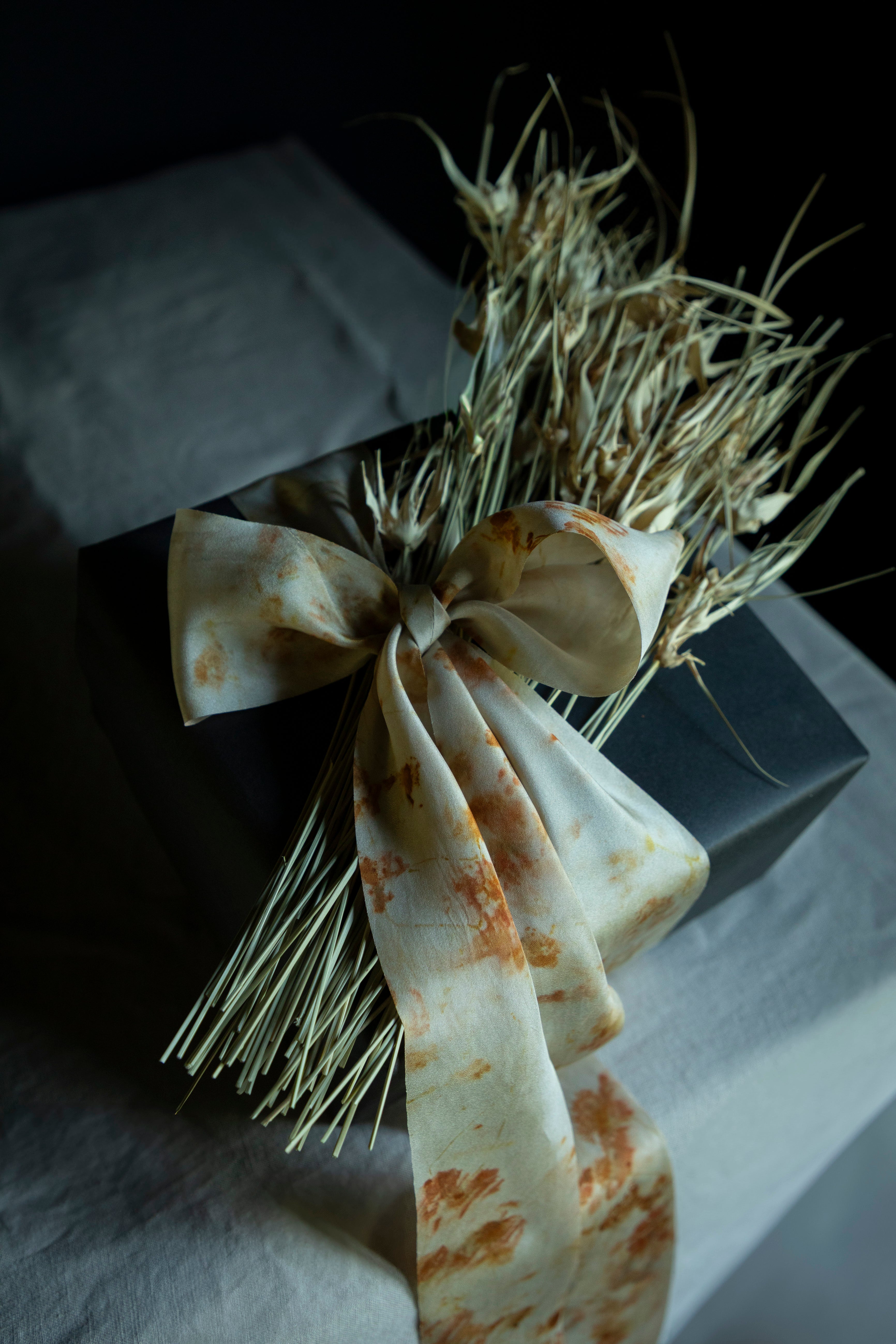 Decorative bow with dried elements on a dark background