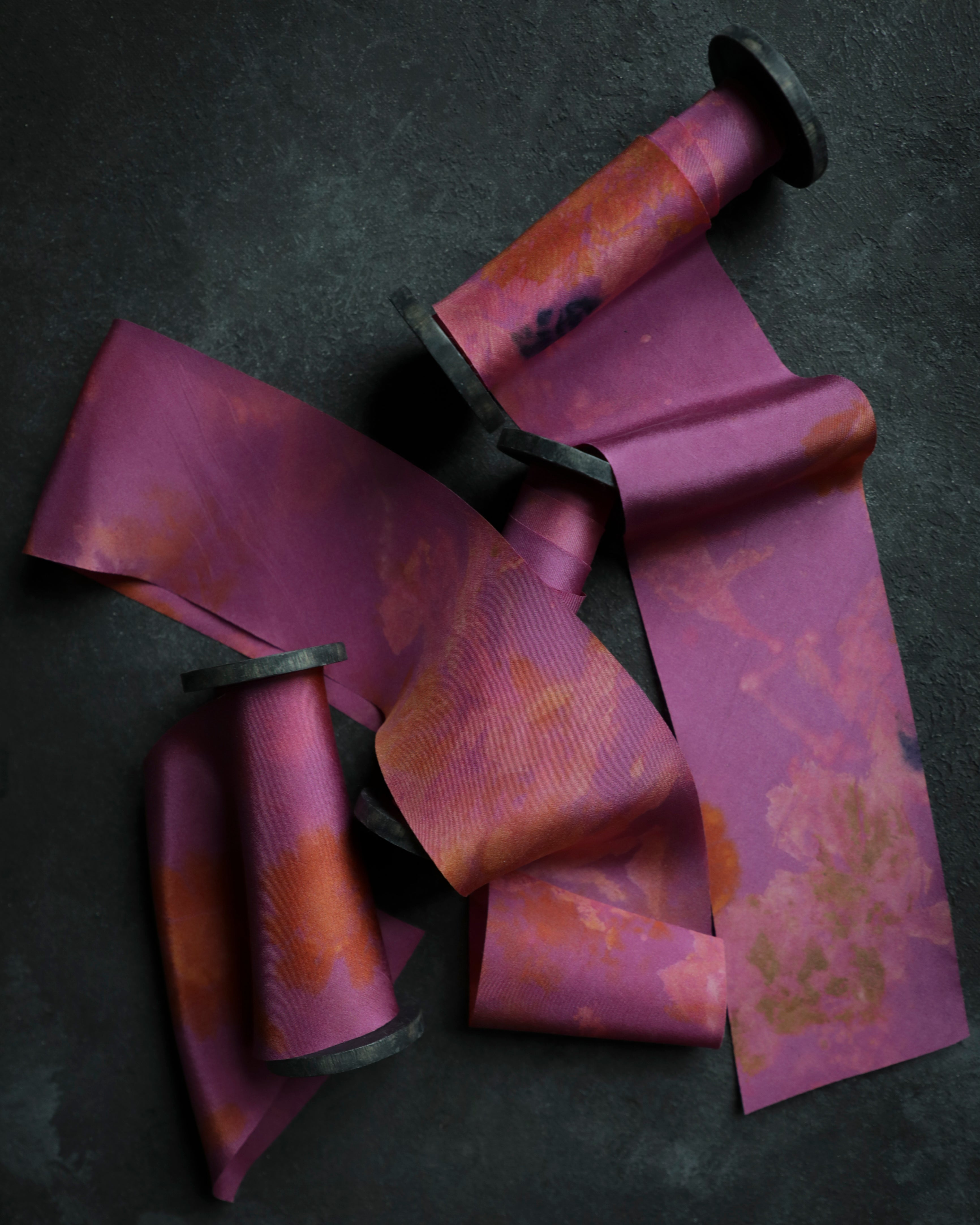 Purple and orange striped ribbon on a dark background