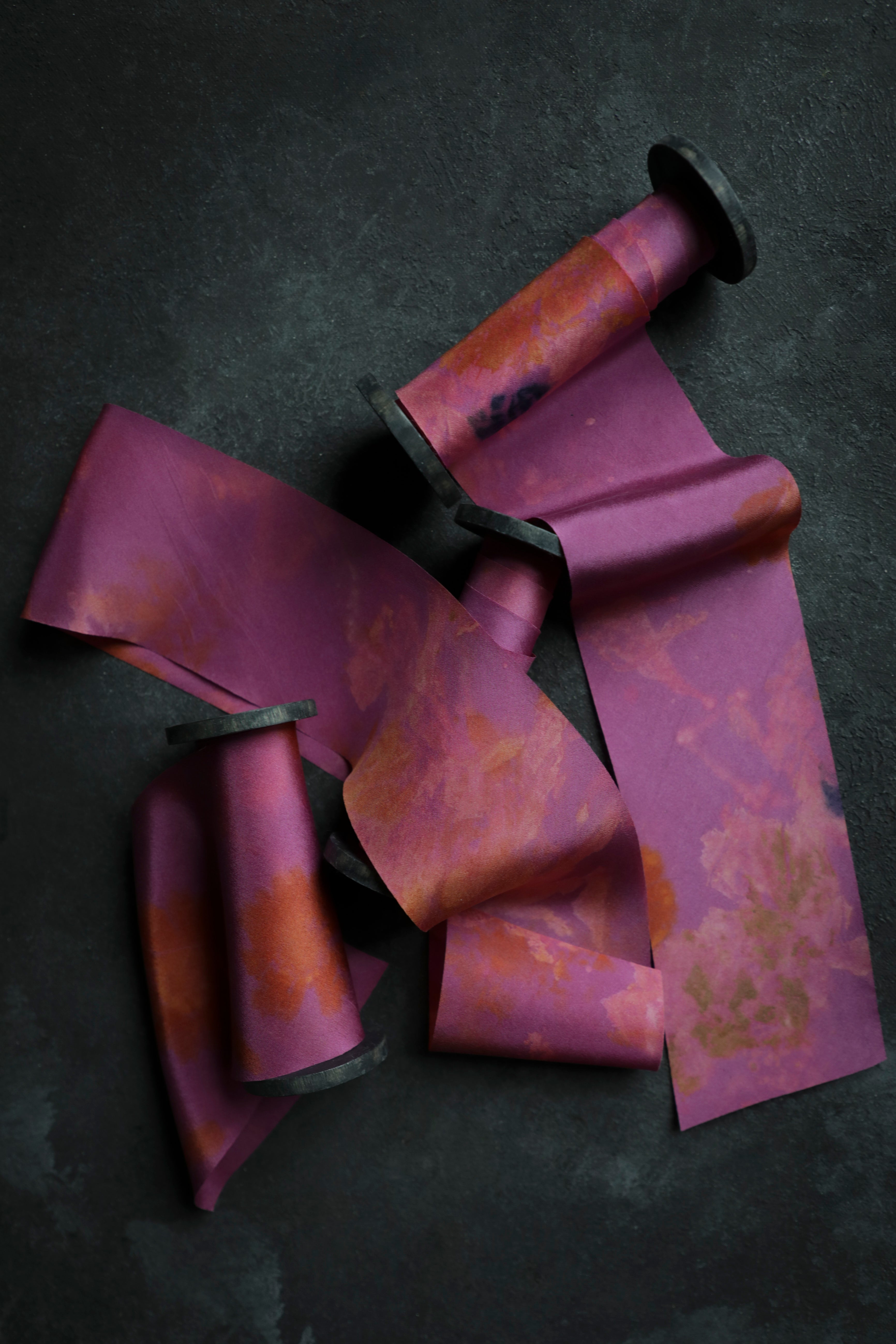 Purple and orange striped ribbon on a dark background