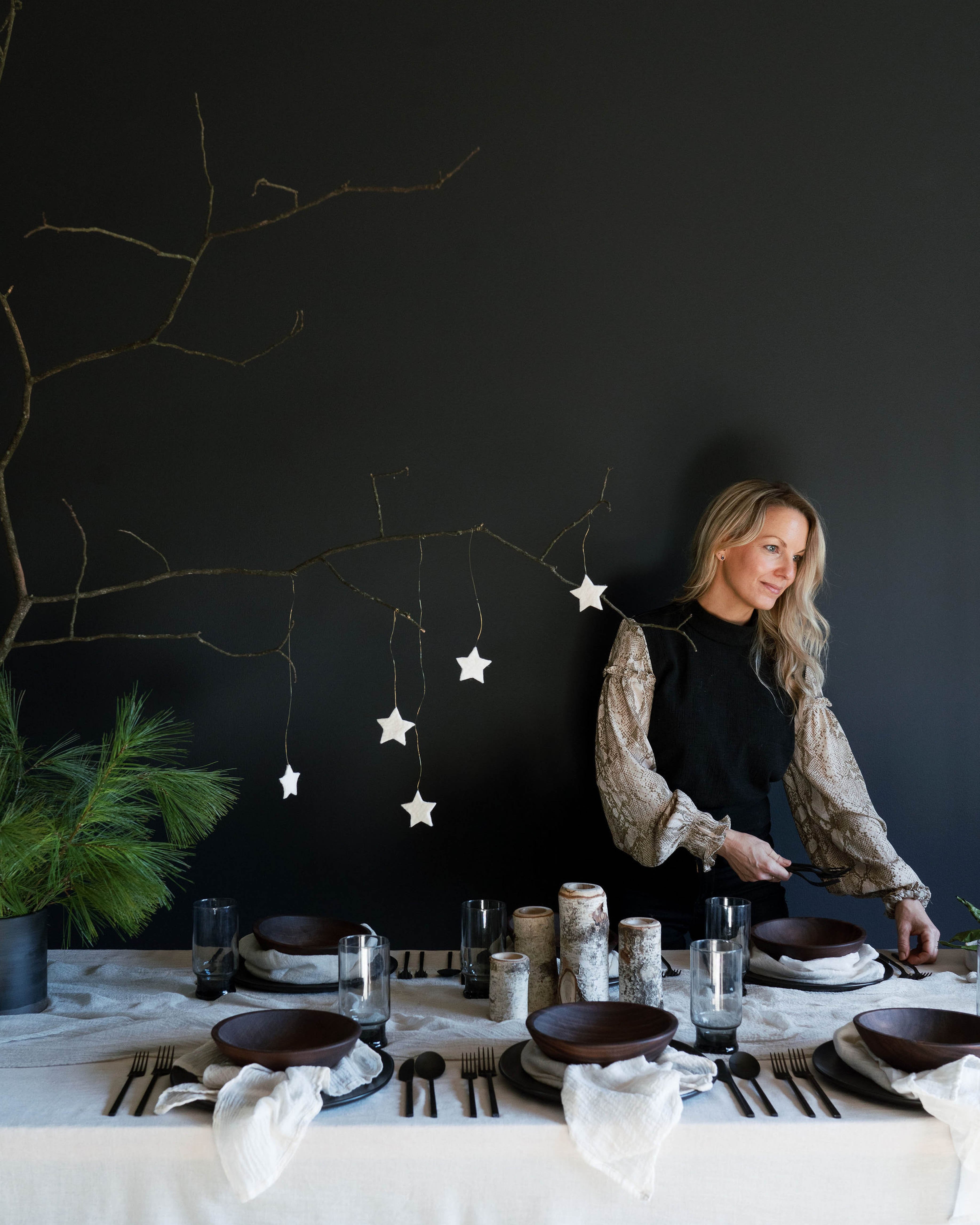 An elegantly set Nordic winter table featuring antique white, plant-dyed, handloomed cotton napkins, showcasing a wabi-sabi, organic design that highlights the heirloom quality of the table linens. Perfect for anyone seeking to create a serene and sophisticated winter tablescape.