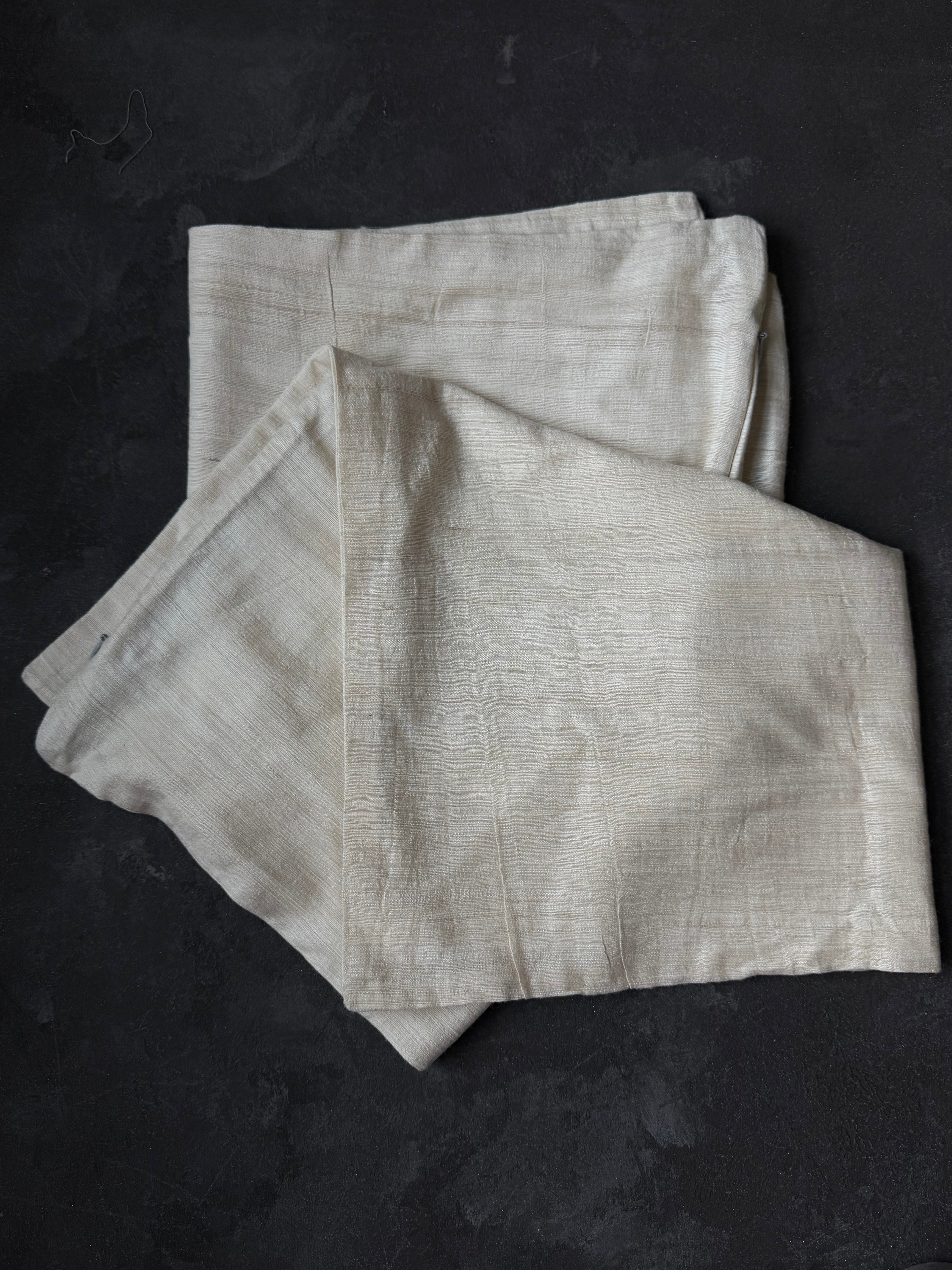 Folded light gray fabric on a dark surface