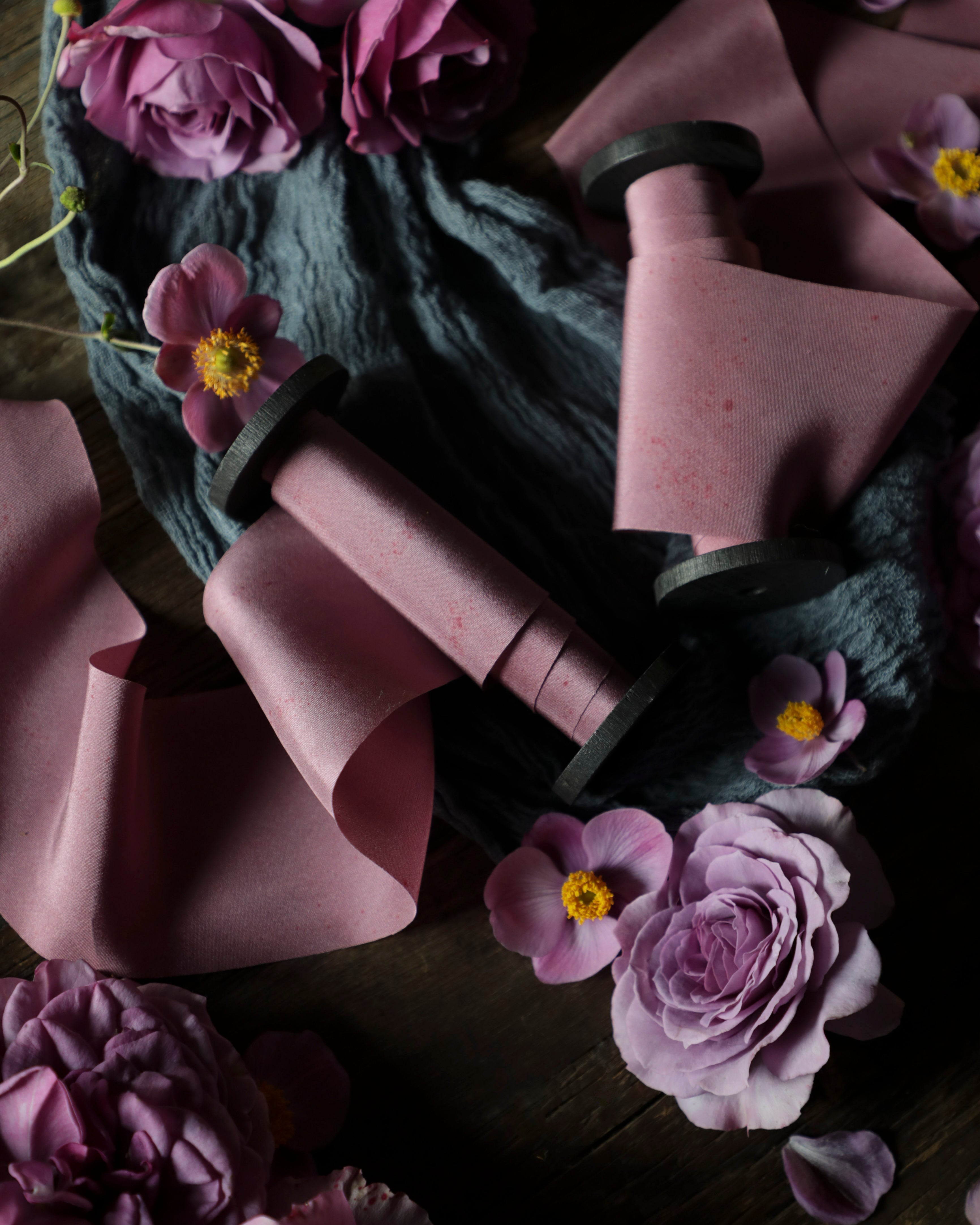 mauve silk ribbon in a flatlay styling on wood backdrop