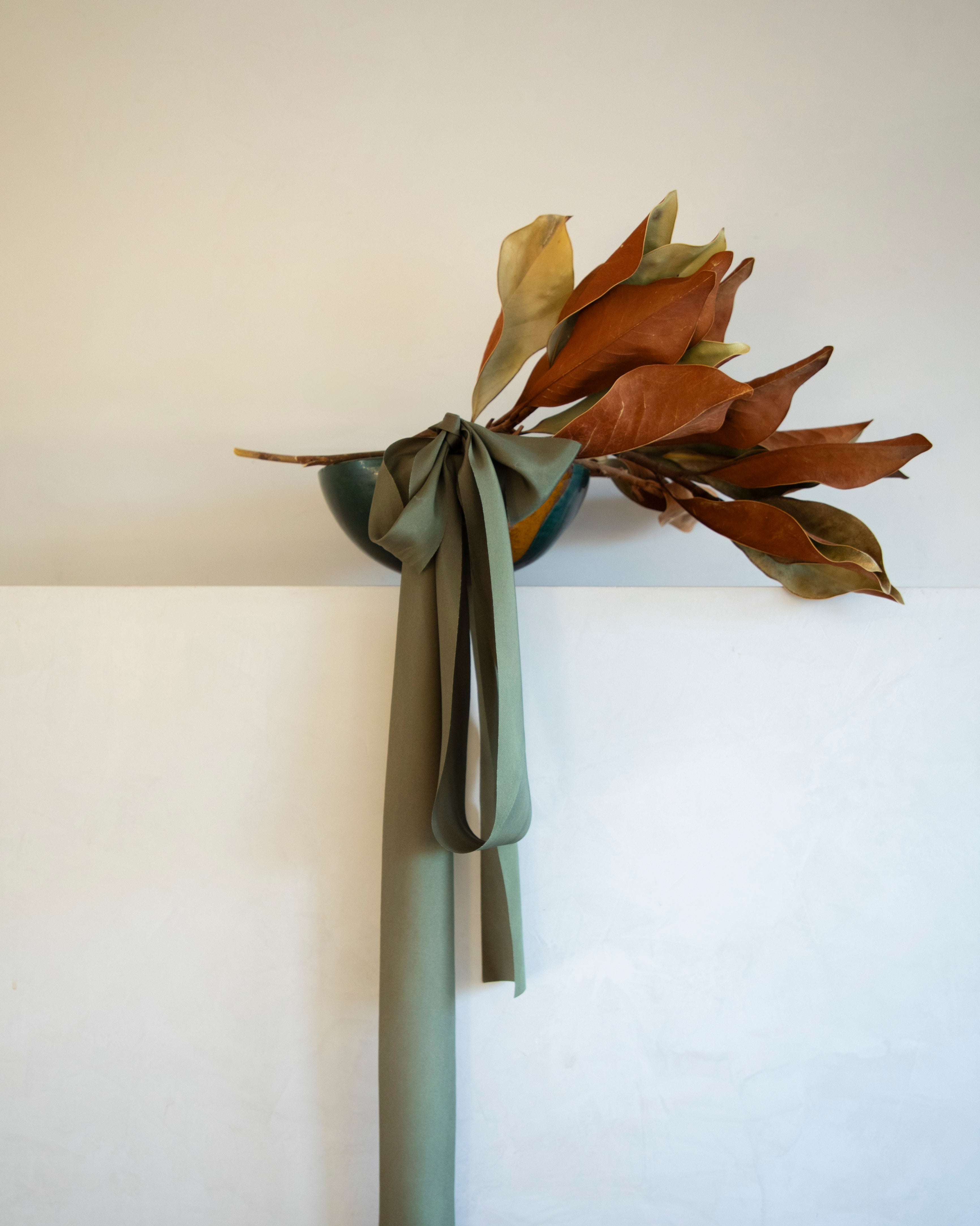 mantel decor with magnolia leaves and emerald green silk ribbon. the best bridal bouquet silk ribbon