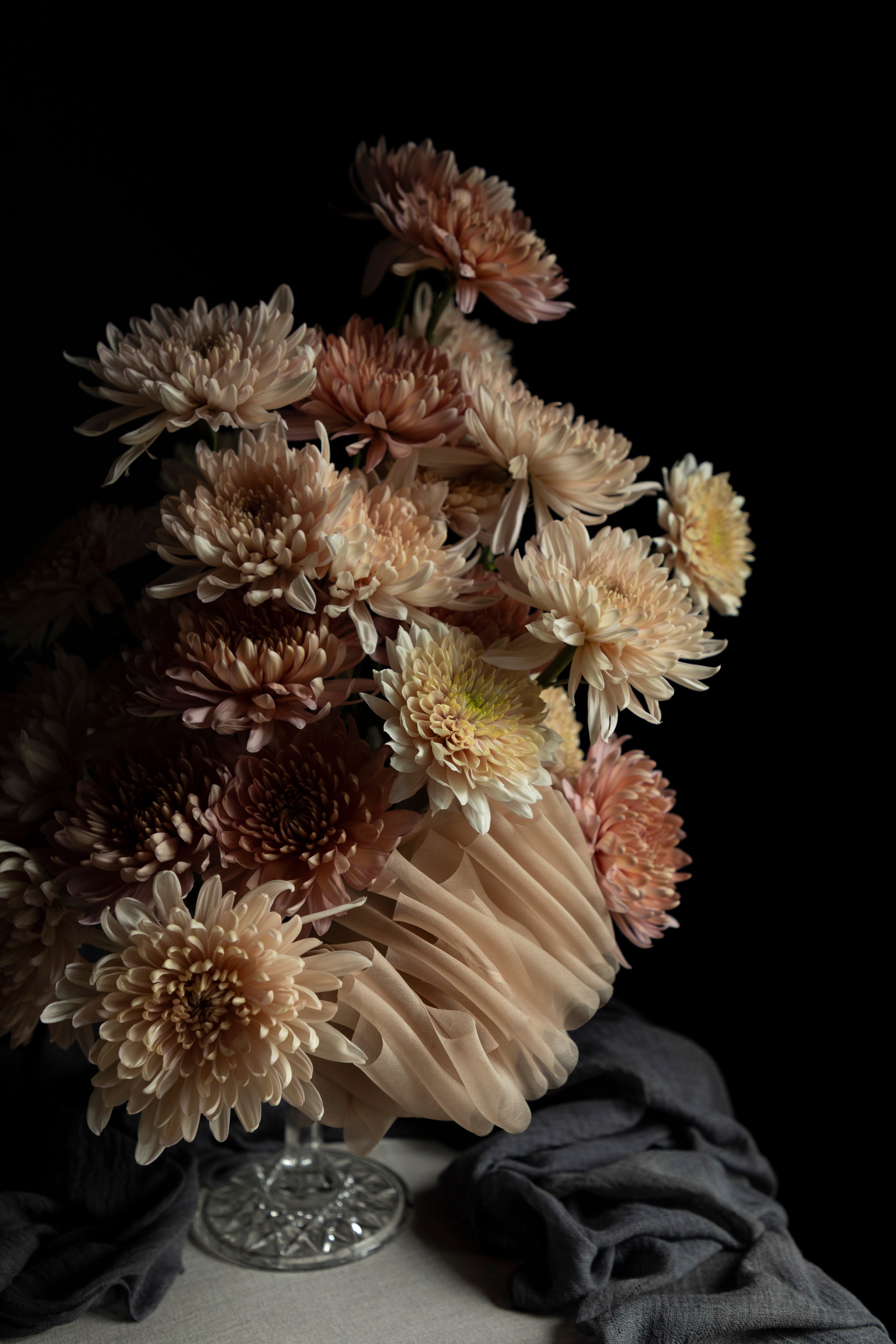 Bouquet of dried flowers in a glass vase on a dark background