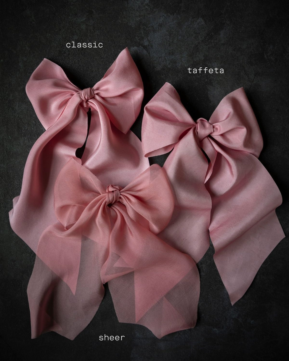 Three pink fabric bows labeled 'classic', 'taffeta', and 'sheer' on a dark background.