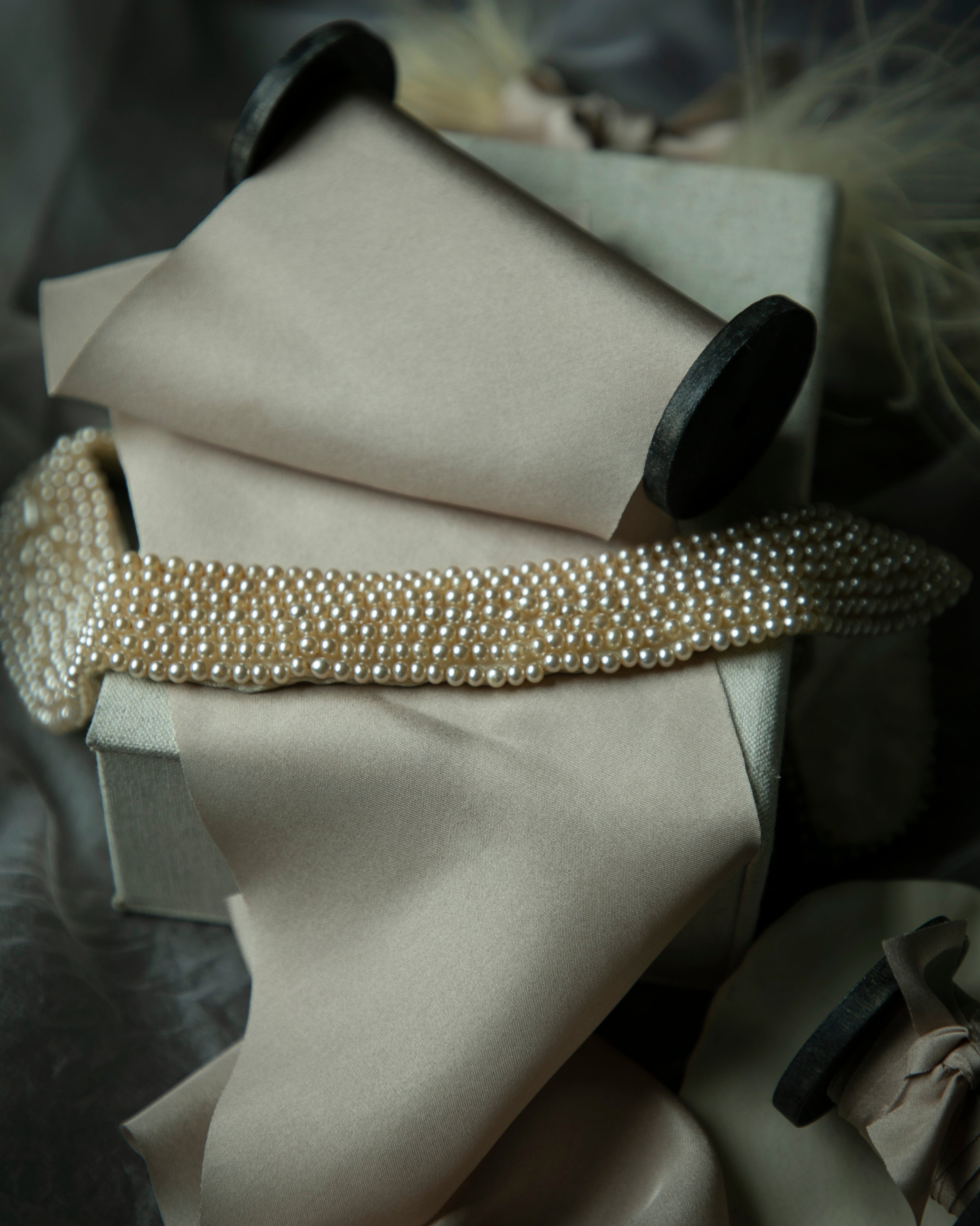 Pearl-studded vintage necklace on display with a blurred background