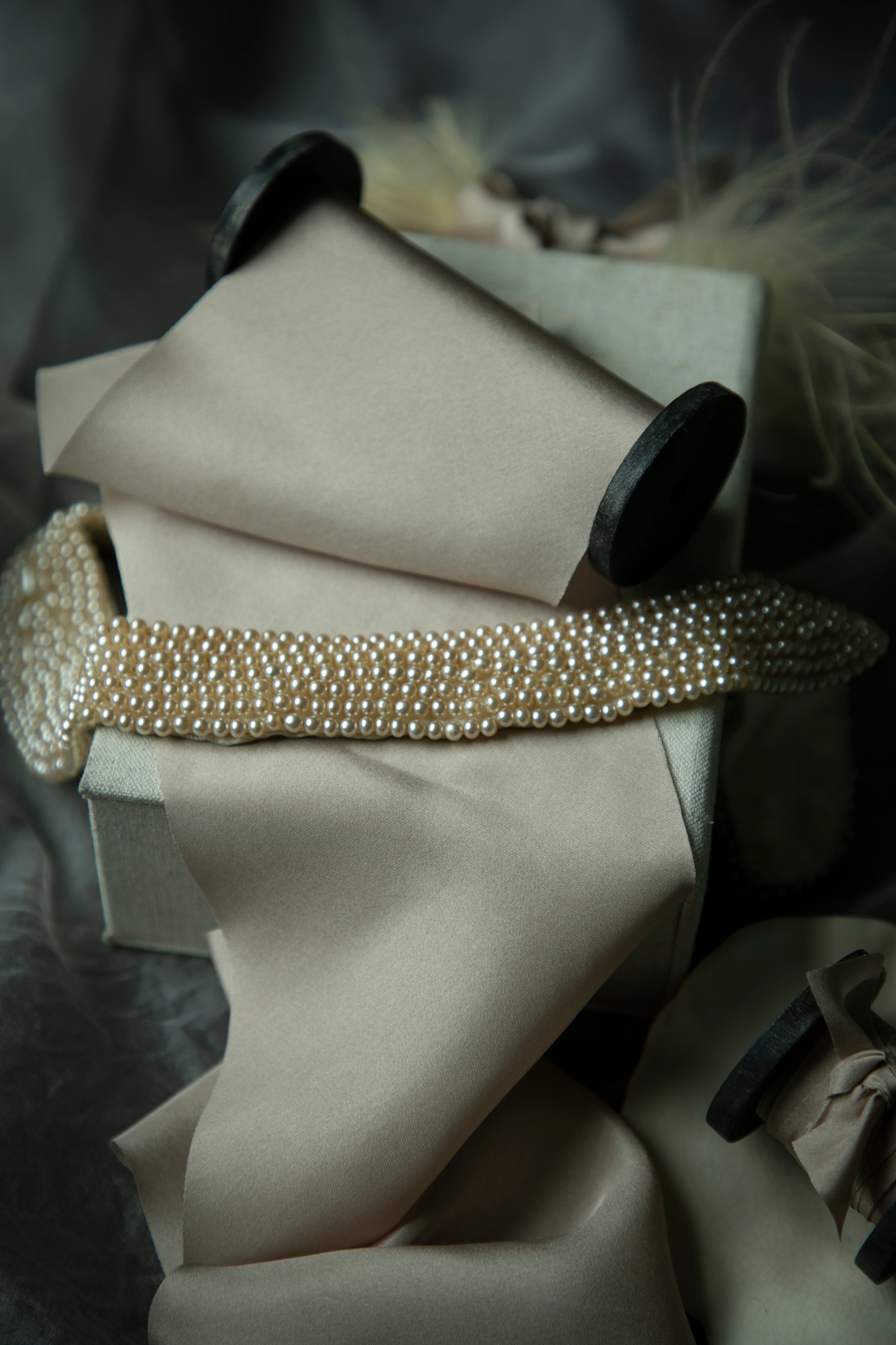 Pearl-studded vintage necklace on display with a blurred background