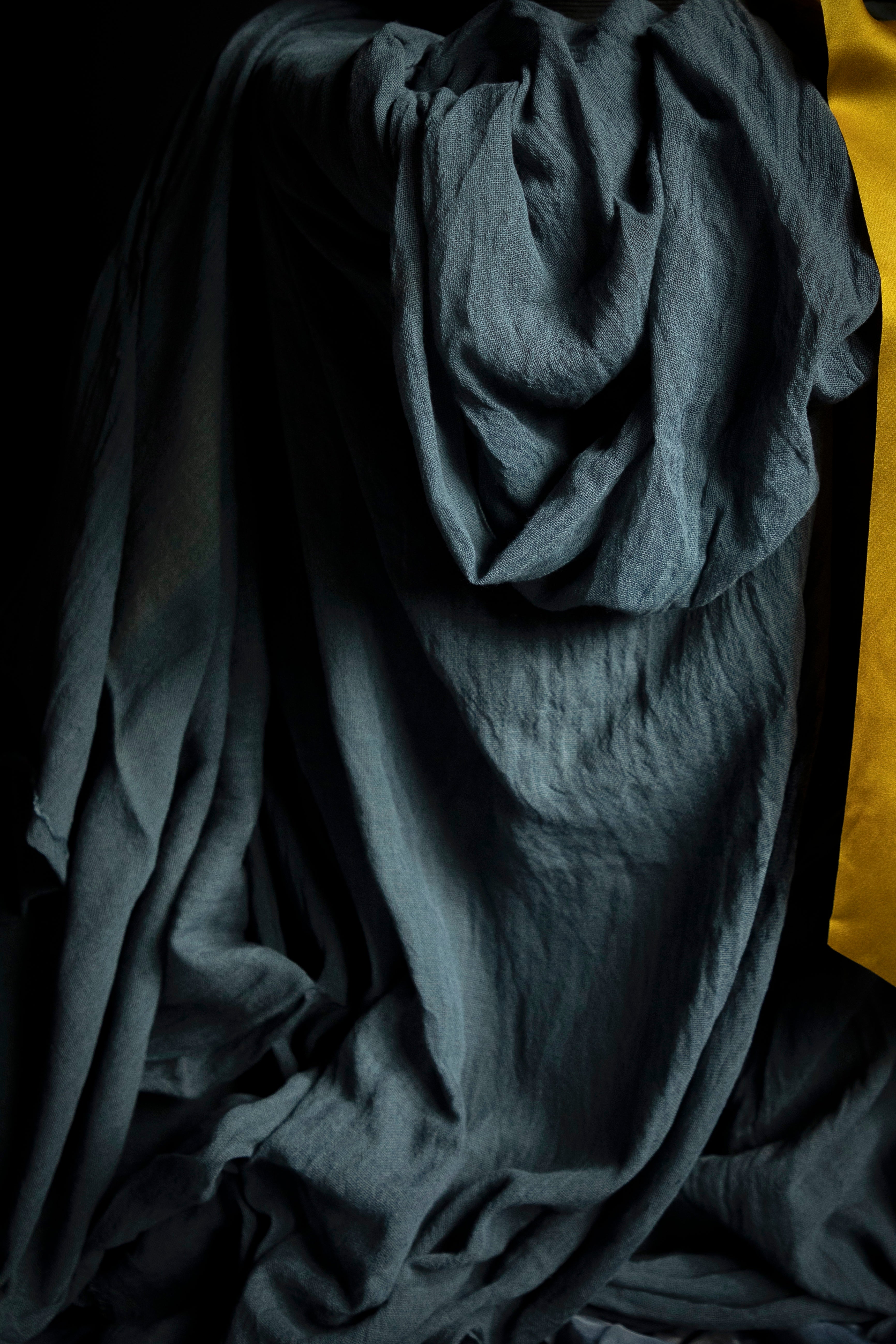 close-up of draping blue colored styling textile with yellow accent.