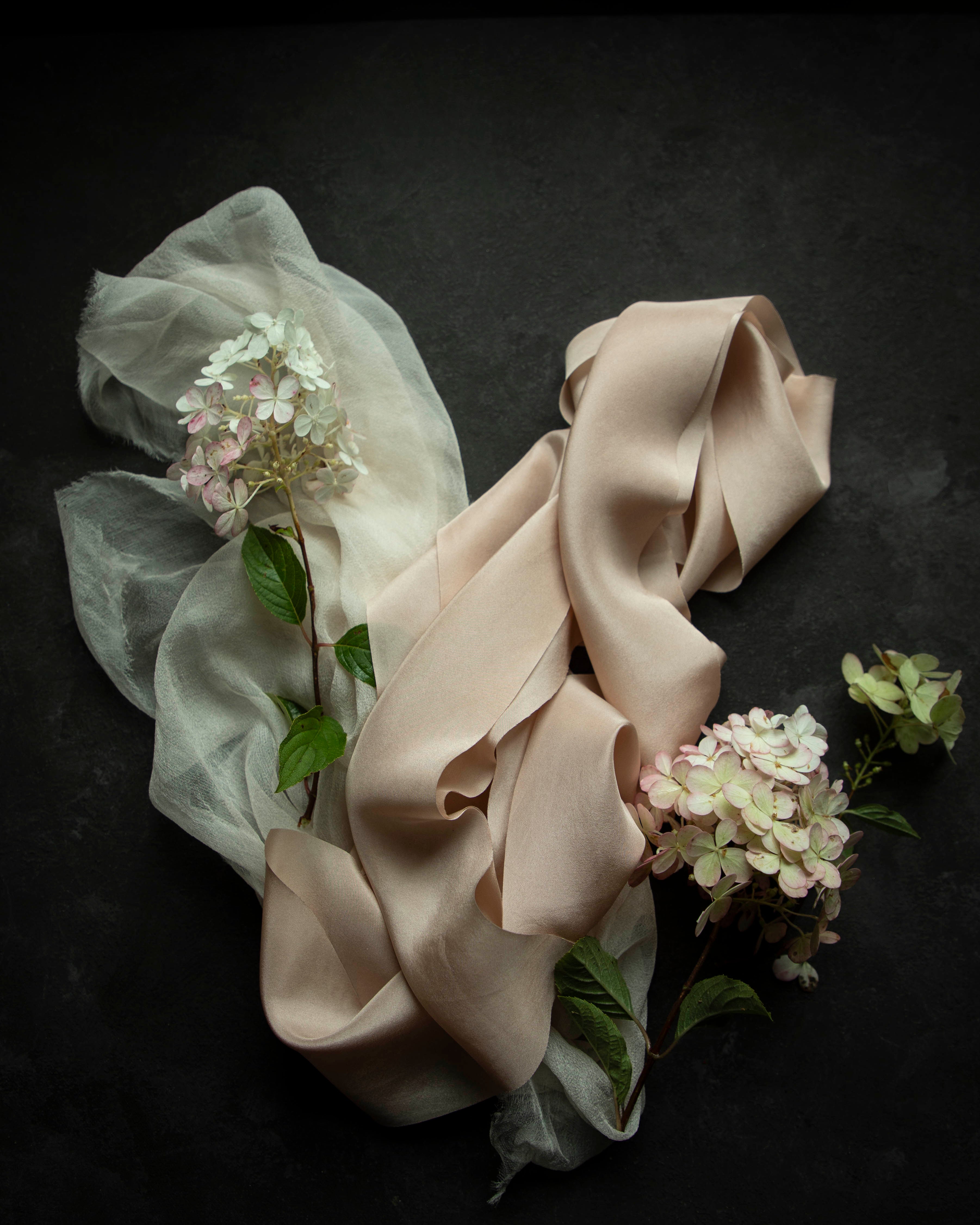 Ruffled beige fabric with flowers on a dark background