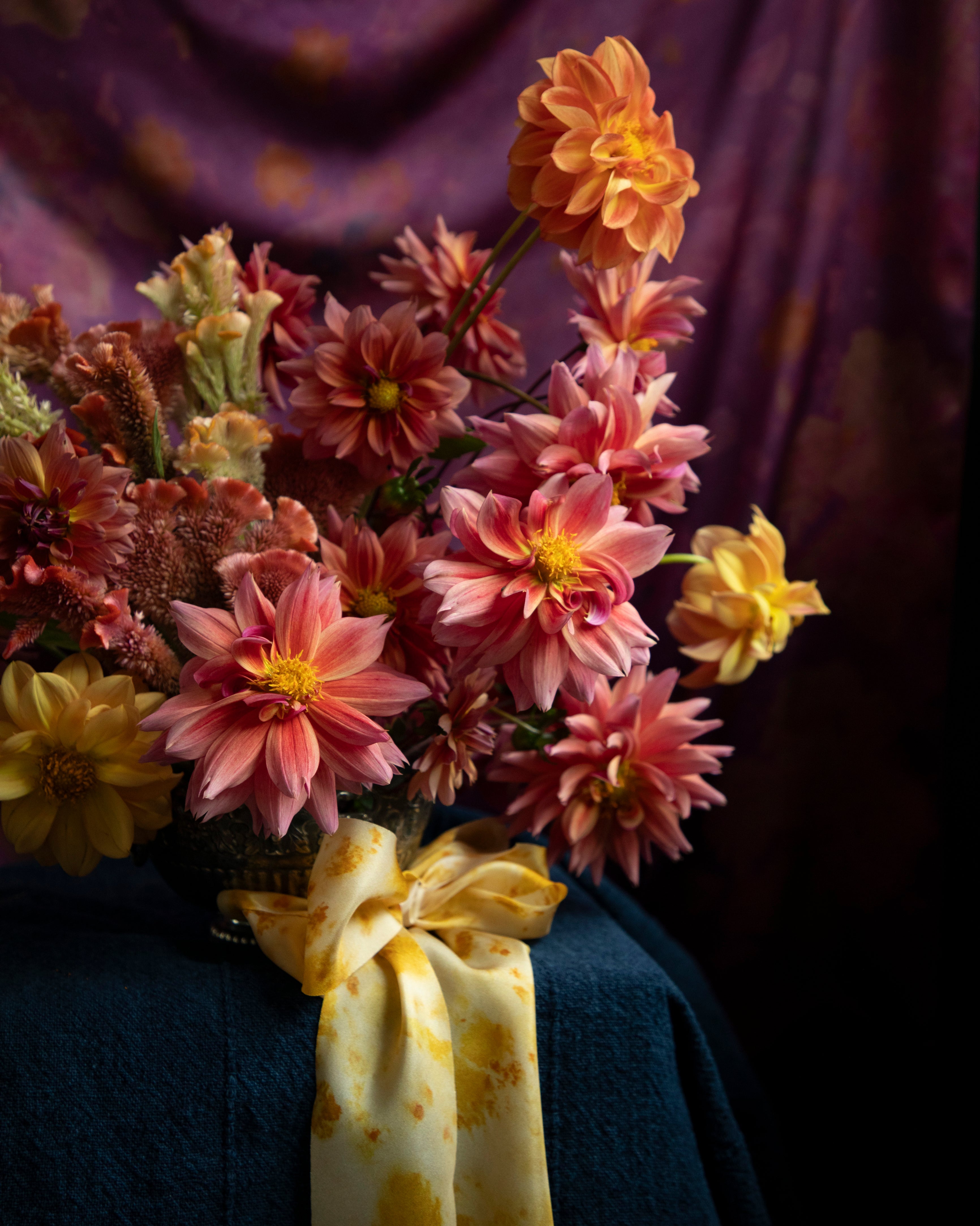 Floral centerpiece with dahlia flowers tied with a silk ribbon bow. Eco-friendly silk ribbons with nature-inspired patterns, perfect for unique gift wrapping and tying market bouquets, crafted from sustainable materials