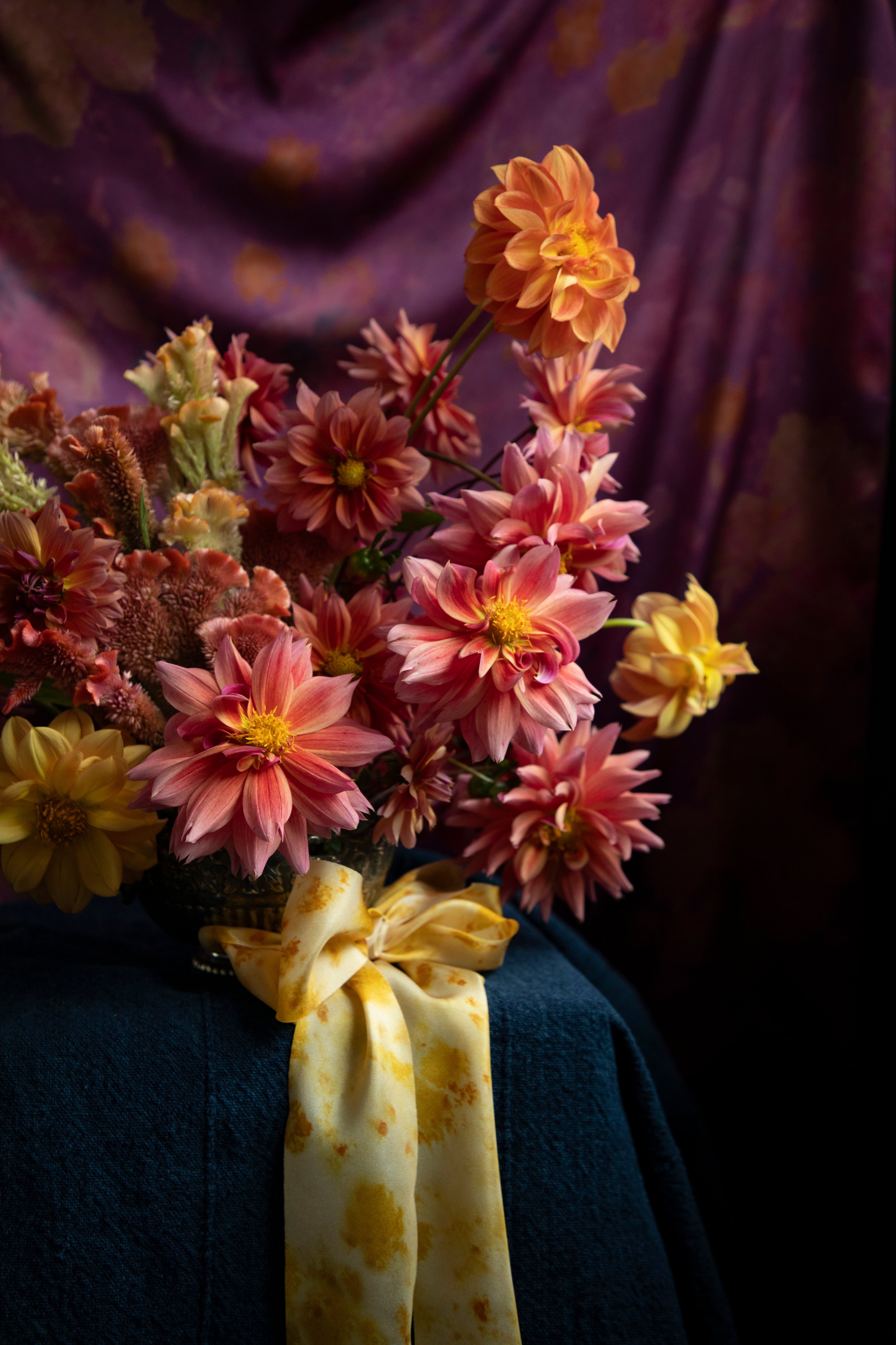 Floral centerpiece with dahlia flowers tied with a silk ribbon bow. Eco-friendly silk ribbons with nature-inspired patterns, perfect for unique gift wrapping and tying market bouquets, crafted from sustainable materials