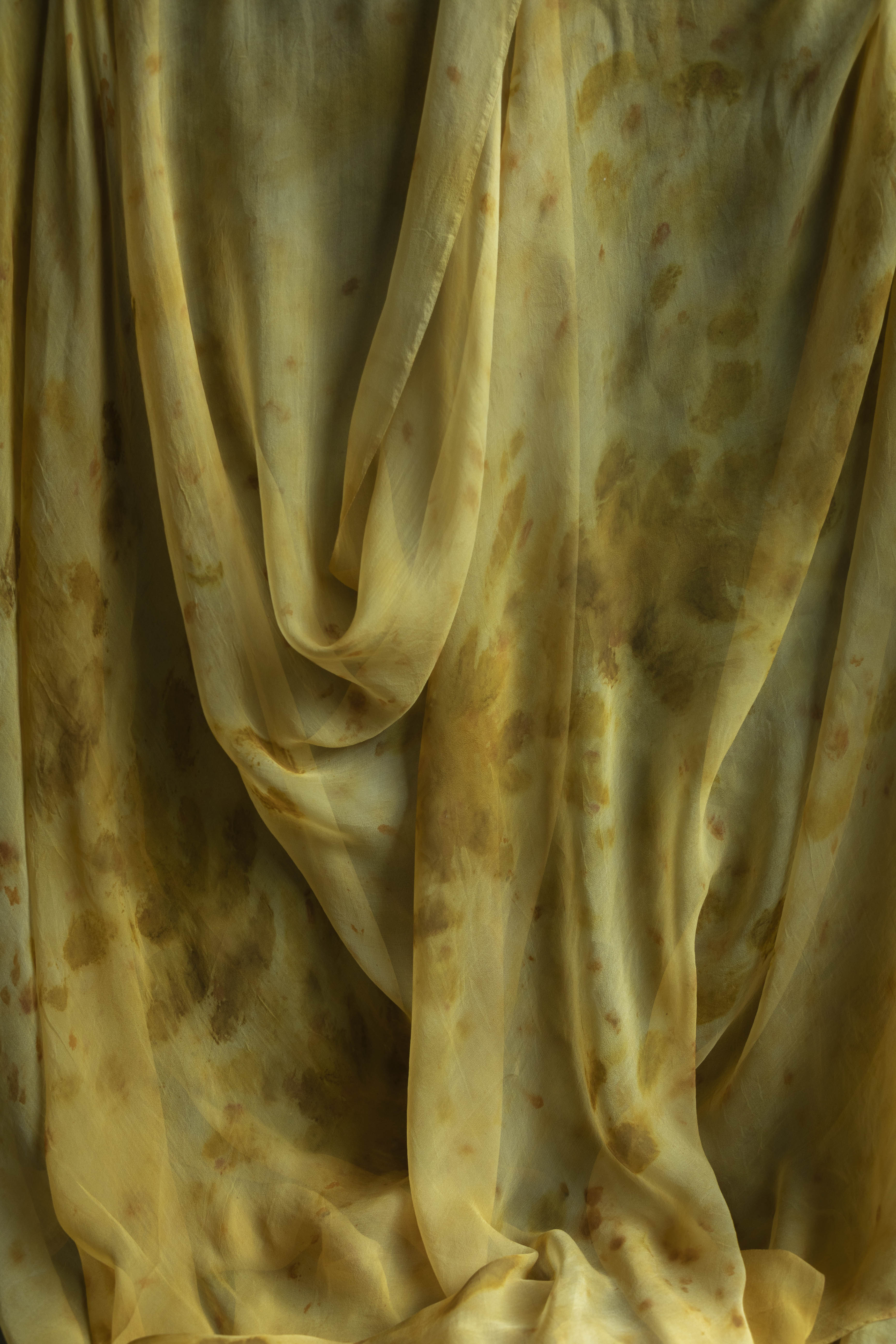 Sheer silk table runner with a botanical print featuring marigolds and chrysanthemums in shades of yellow, gold, burnt orange, and amber.