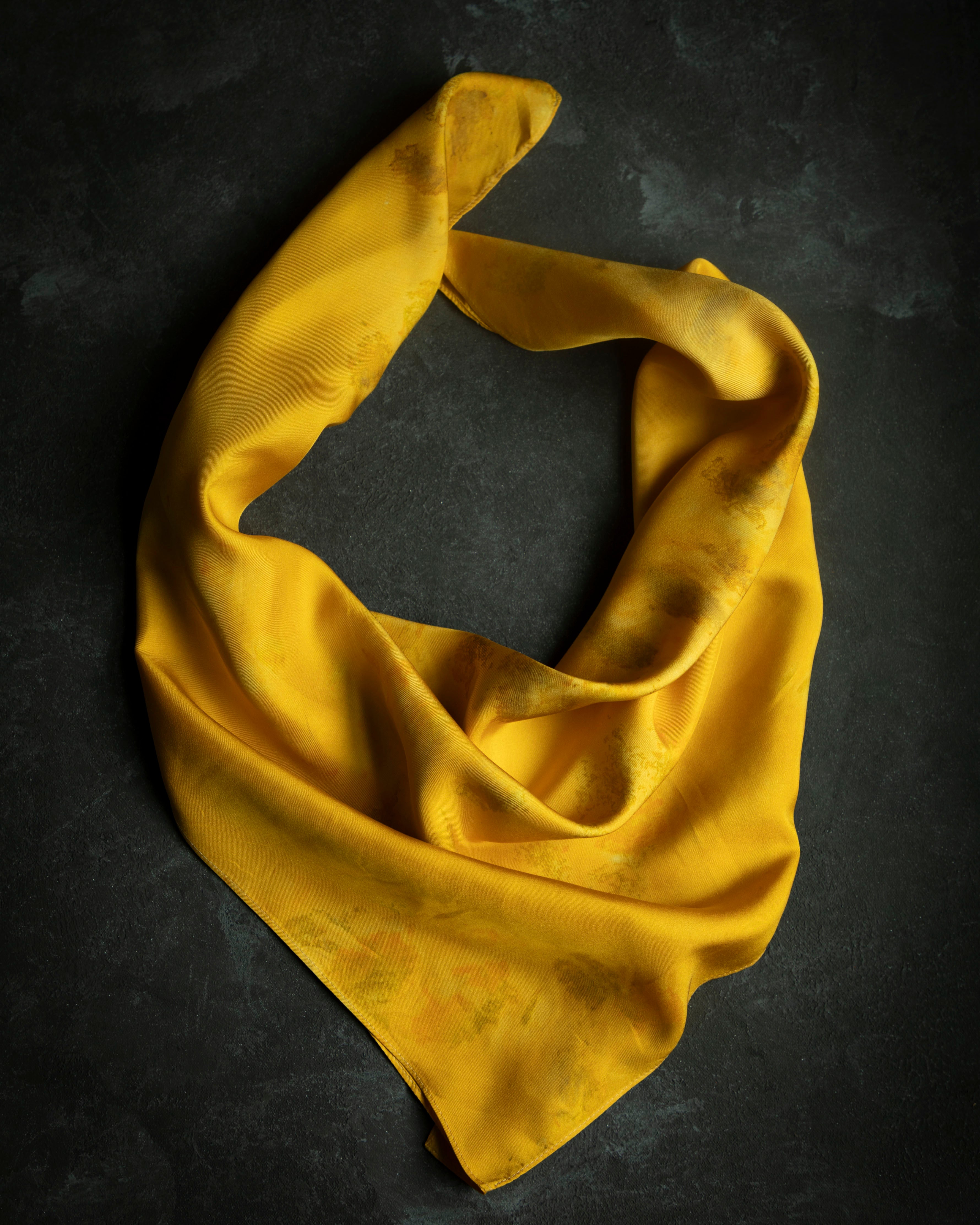 botanically dyed yellow marigold silk scarf. hand crafted by stetile artist shellie pomeroy. Features an eco-print design of marigold flowers.