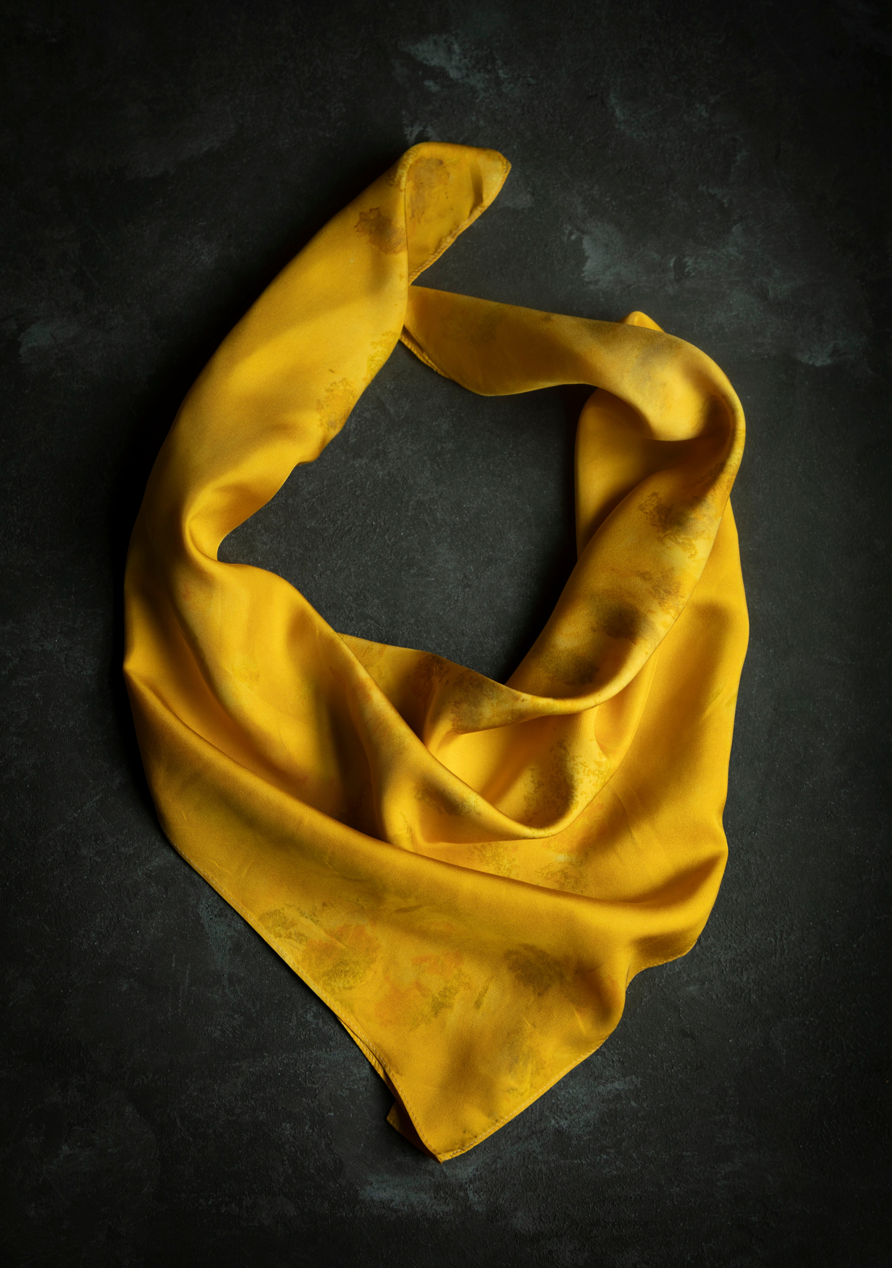 botanically dyed yellow marigold silk scarf. hand crafted by stetile artist shellie pomeroy. Features an eco-print design of marigold flowers.