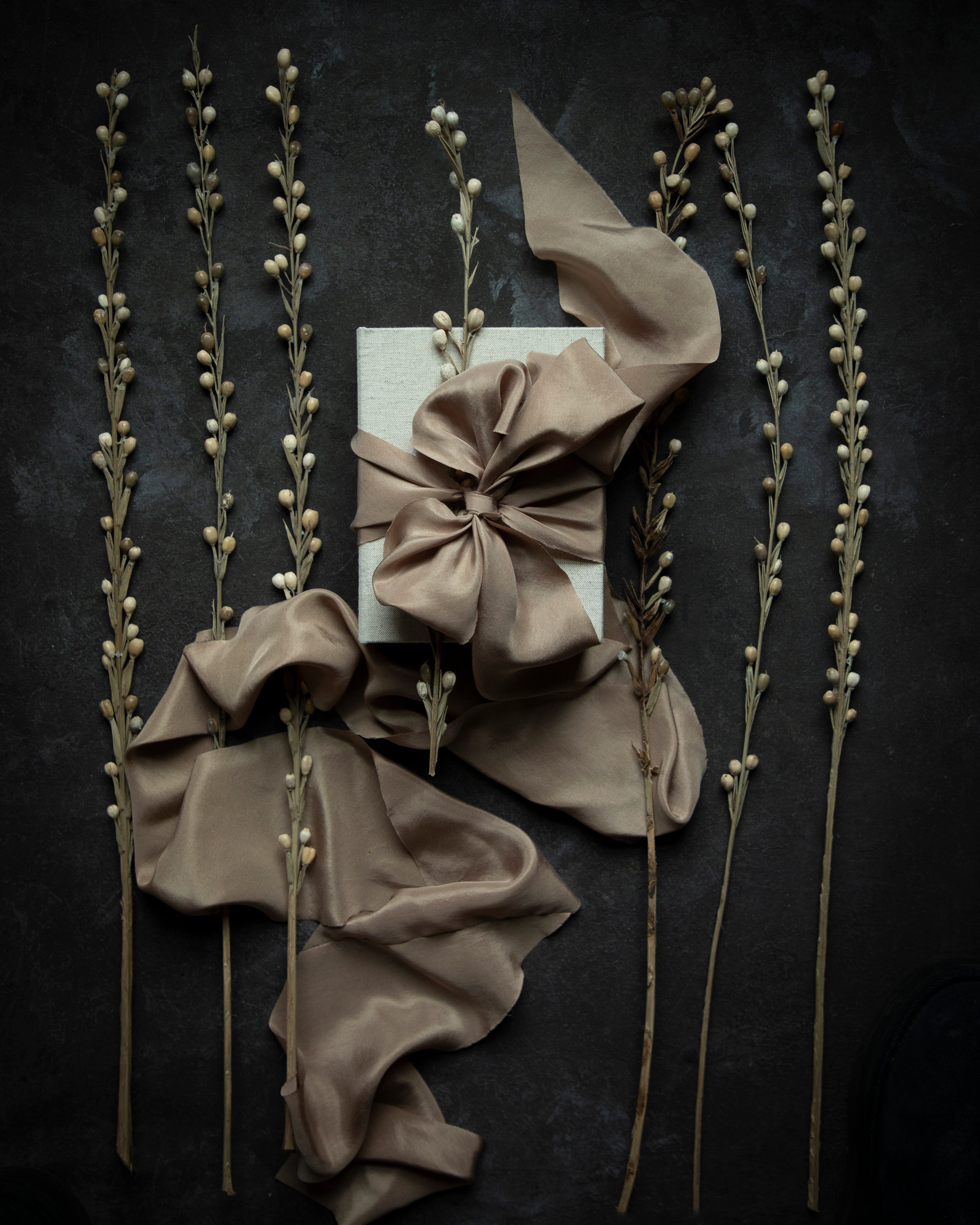 Decorative arrangement with ribbons and twigs on a dark background