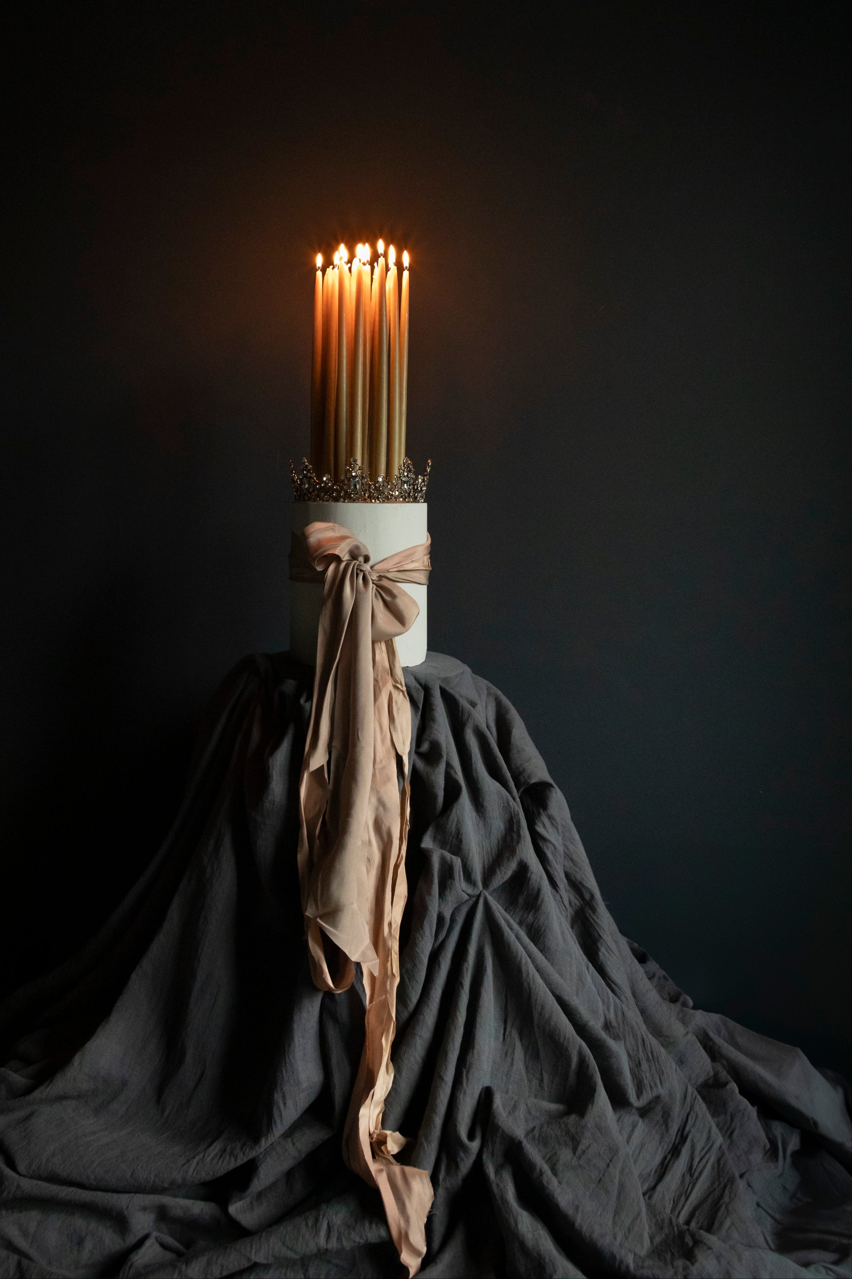 A charcoal gray, solid Orion table runner displayed on a dark background, presented in a manner that highlights its texture and color.