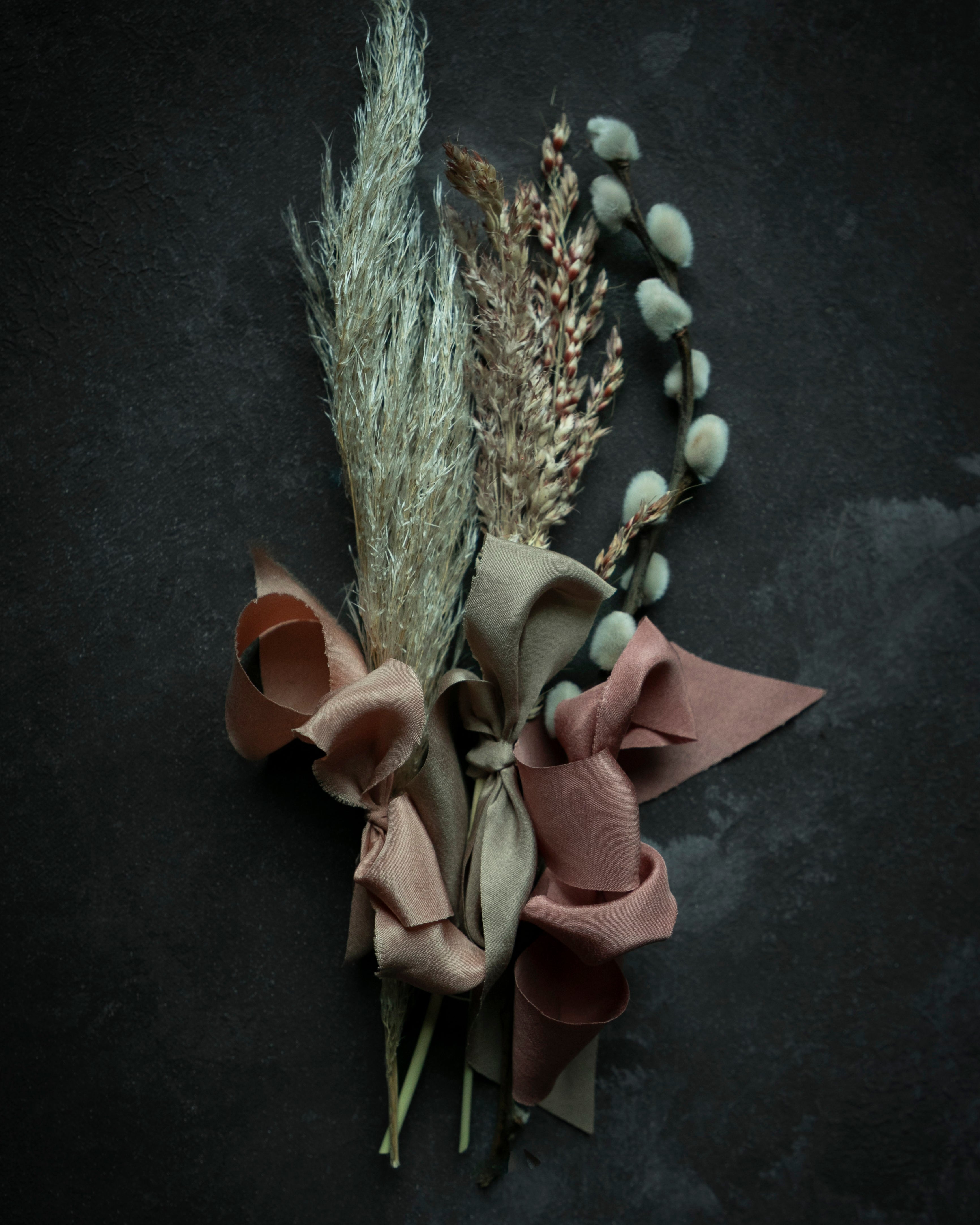 dried fall plants with ribbon bows