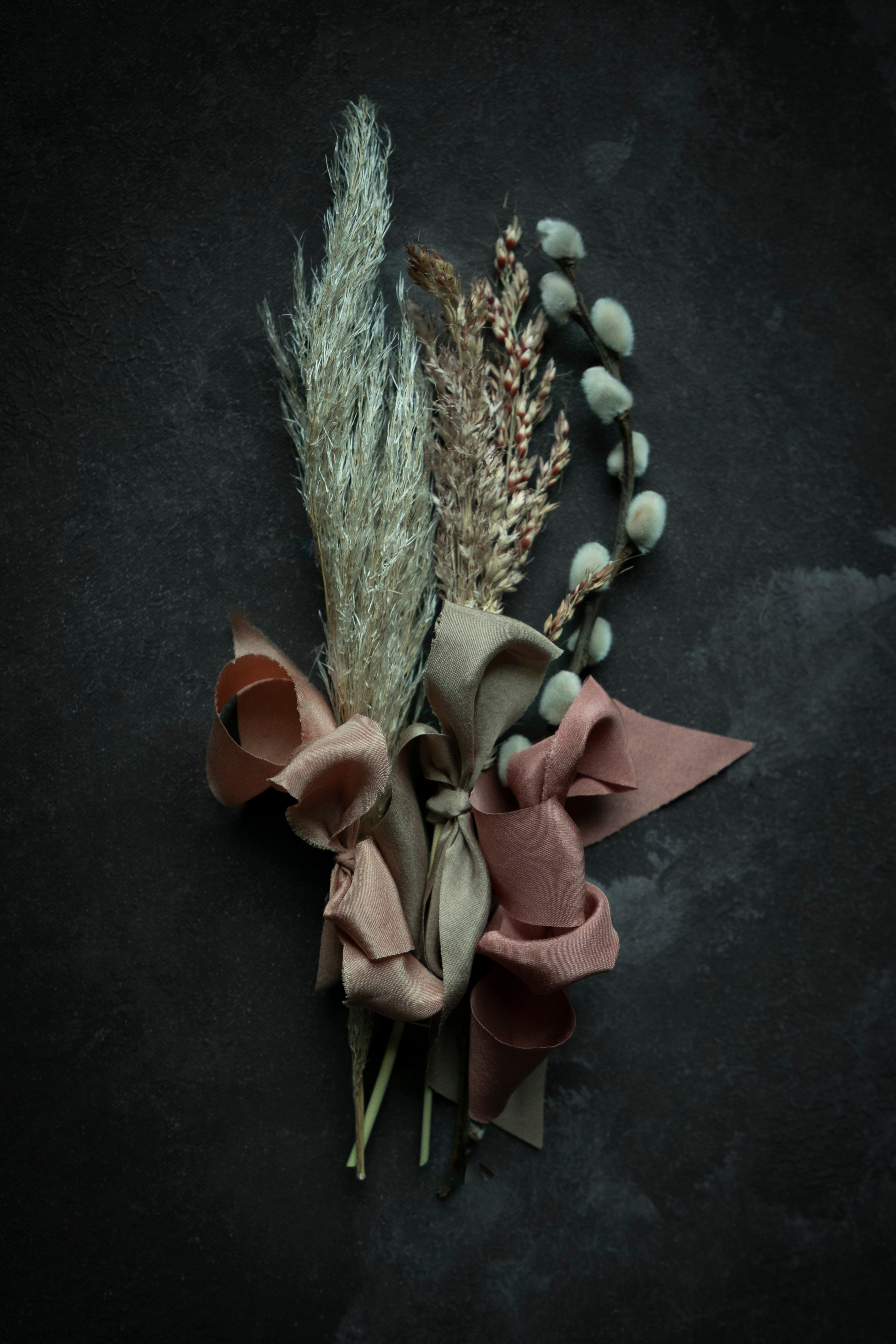 dried fall plants with ribbon bows