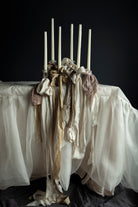 Silk & Willow ribbon stacking experts. White silk wedding table with candles with ribbon stacking