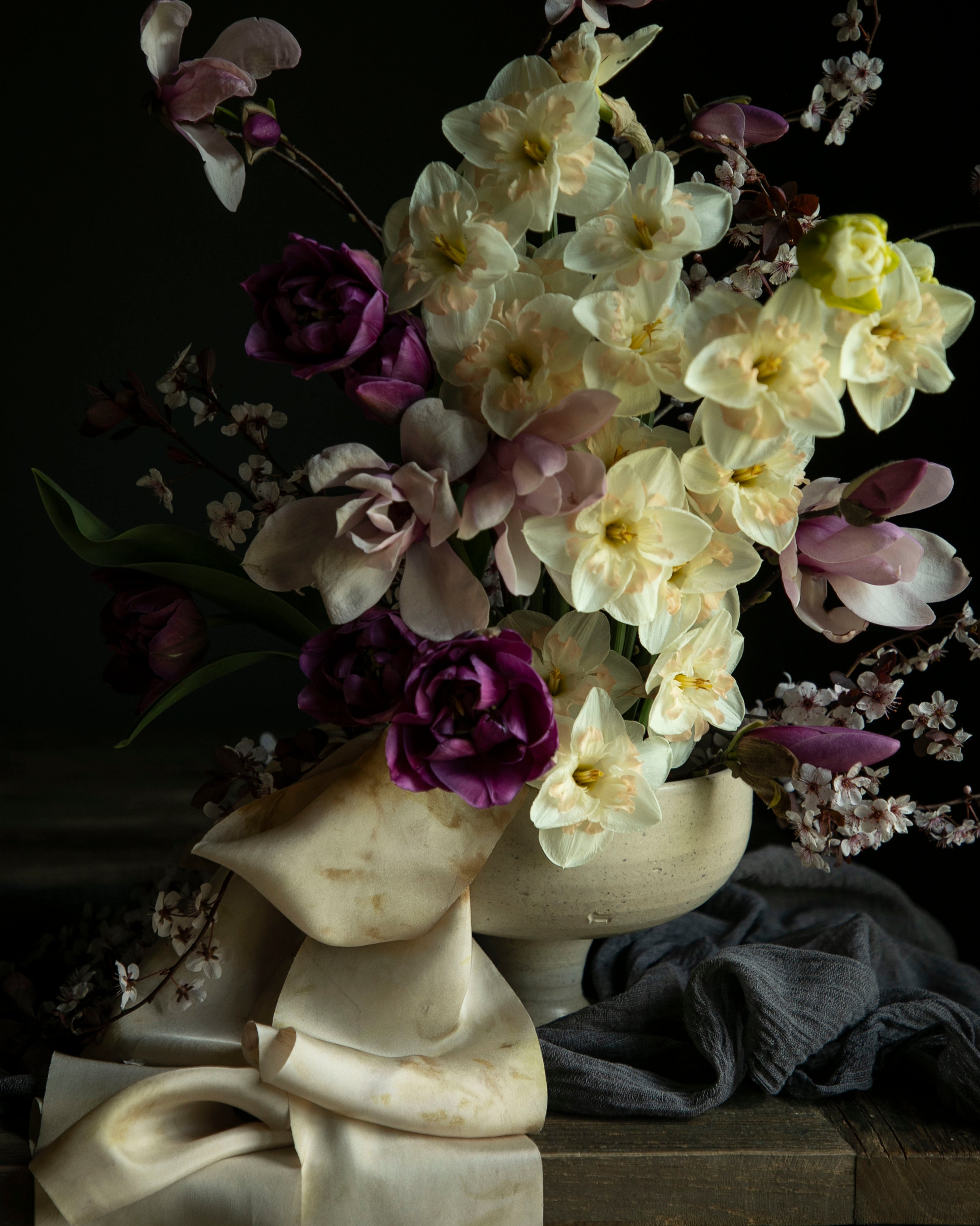 Floral arrangement in a marble vase on a dark background
