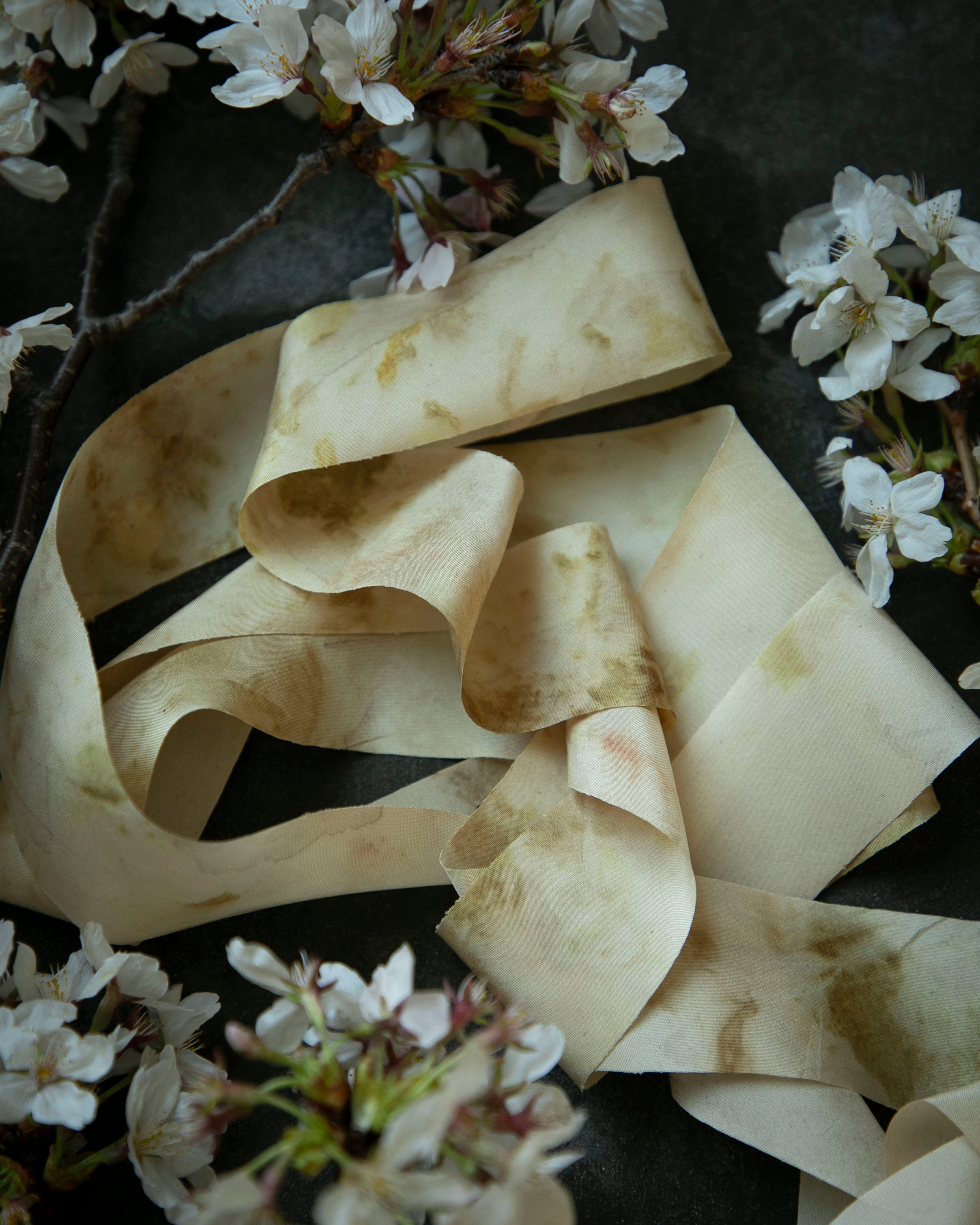 Ruffled bridal bouquet silk ribbon with floral elements on a dark background