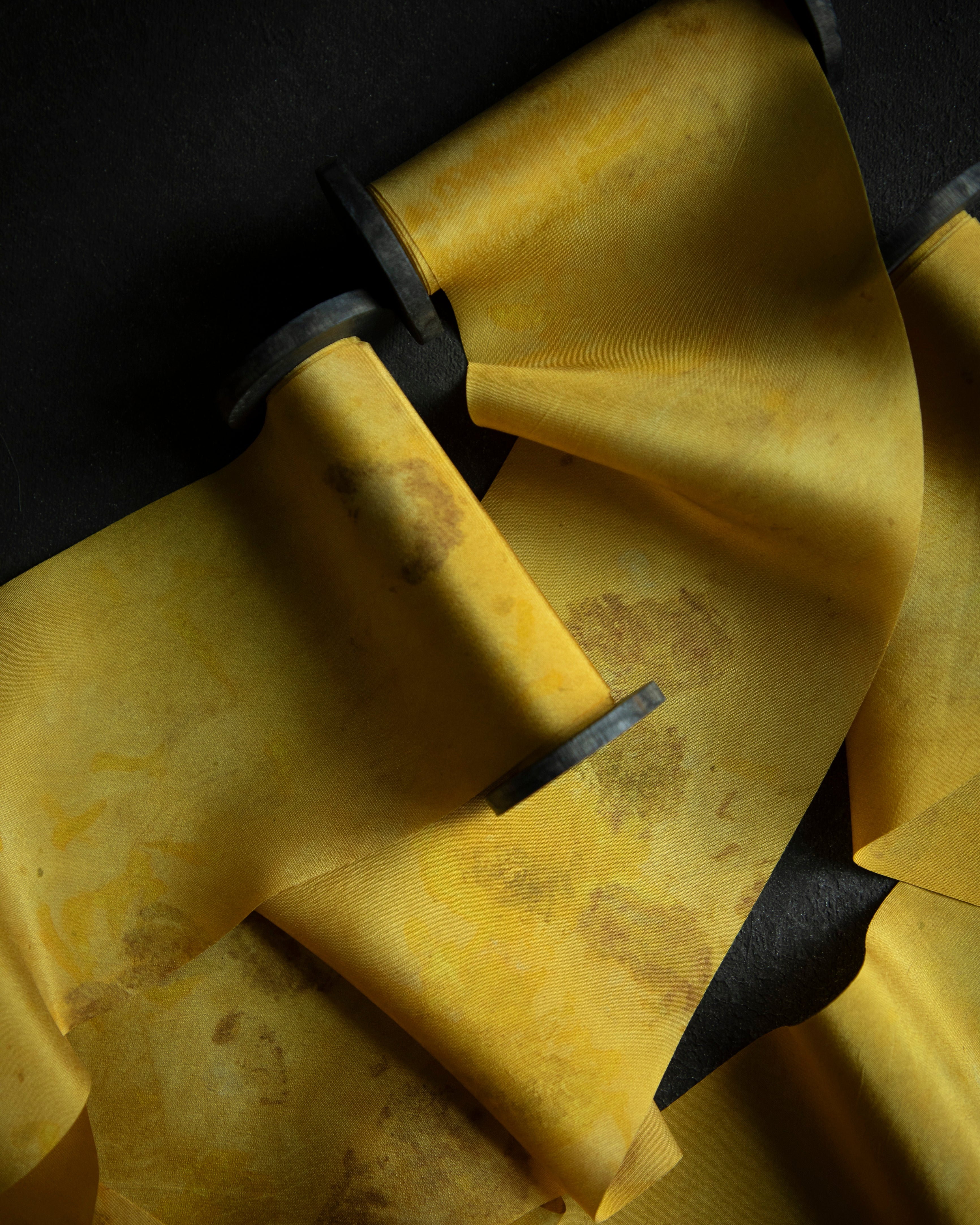 gold hand dyed silk ribbon on black textured background