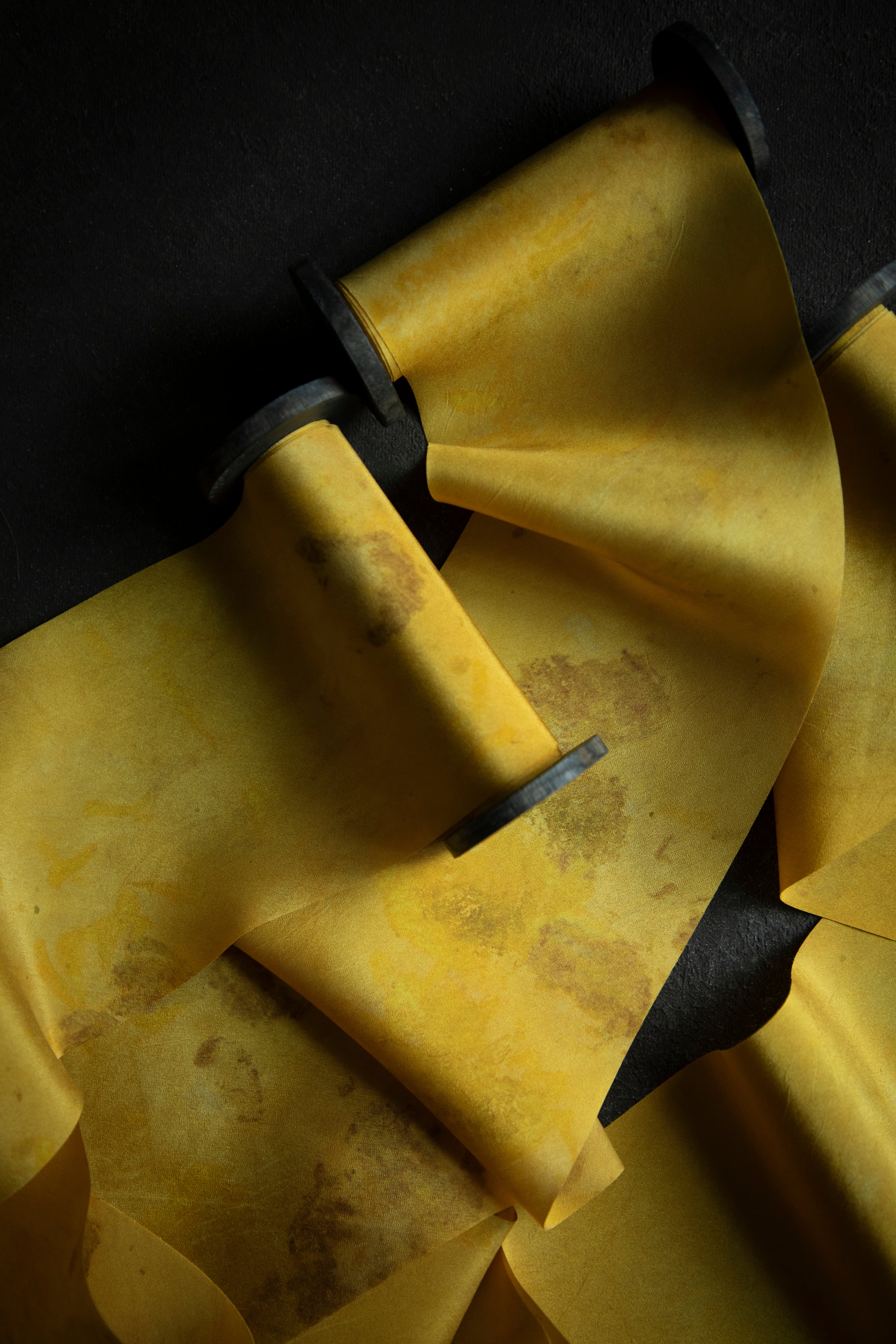 gold hand dyed silk ribbon on black textured background