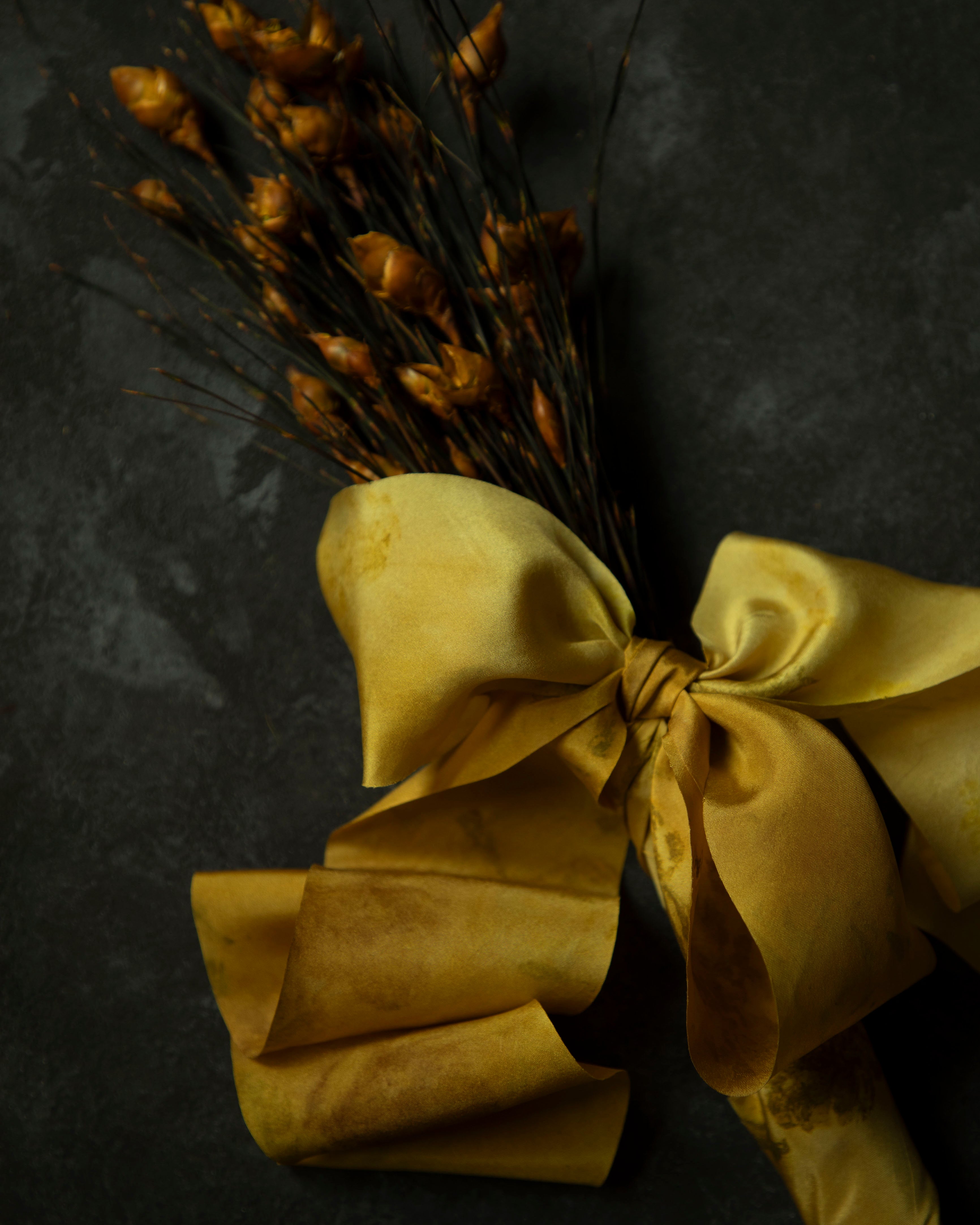 dried bouquet tied with gold silk ribbon