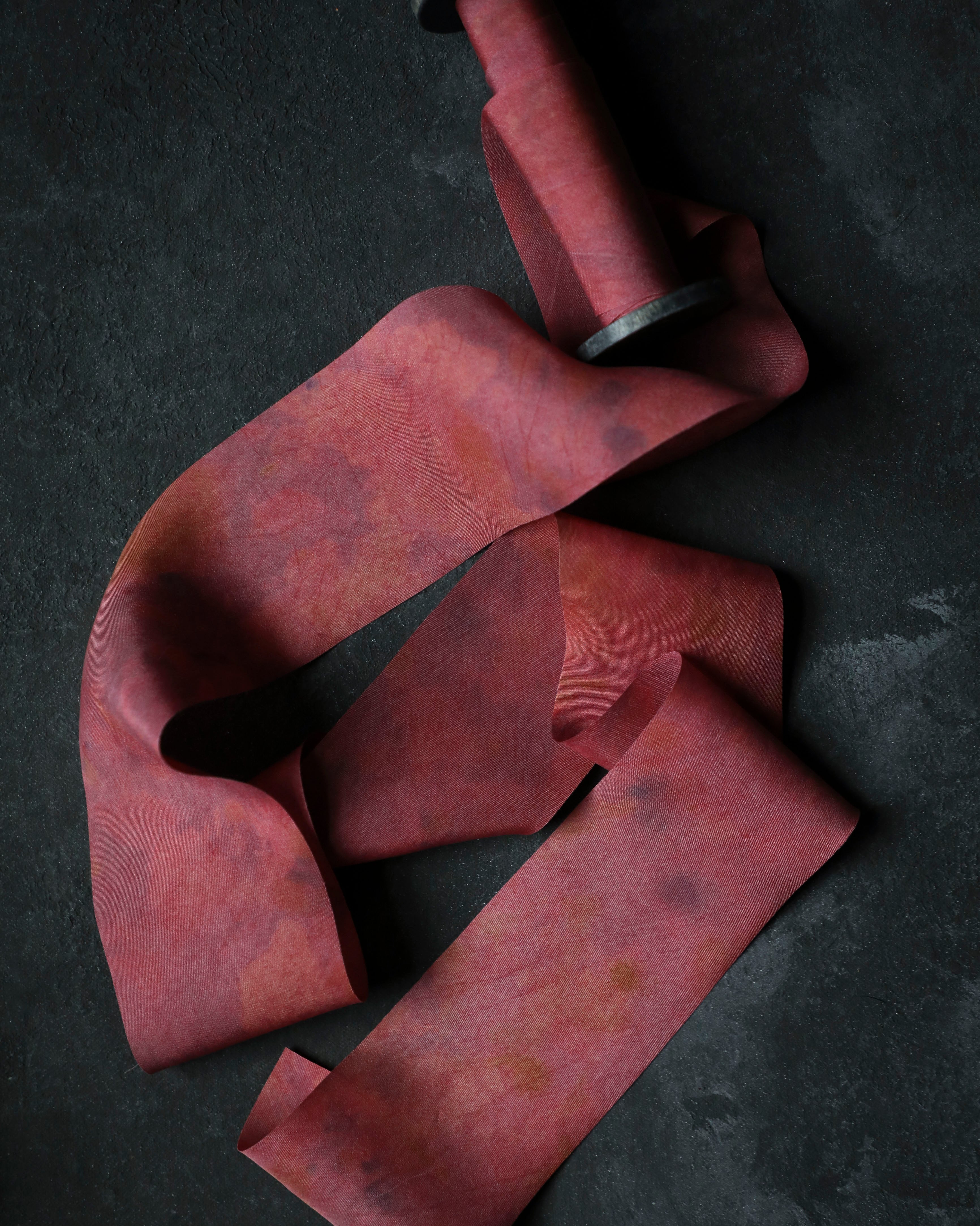 red ribbon on wood spool