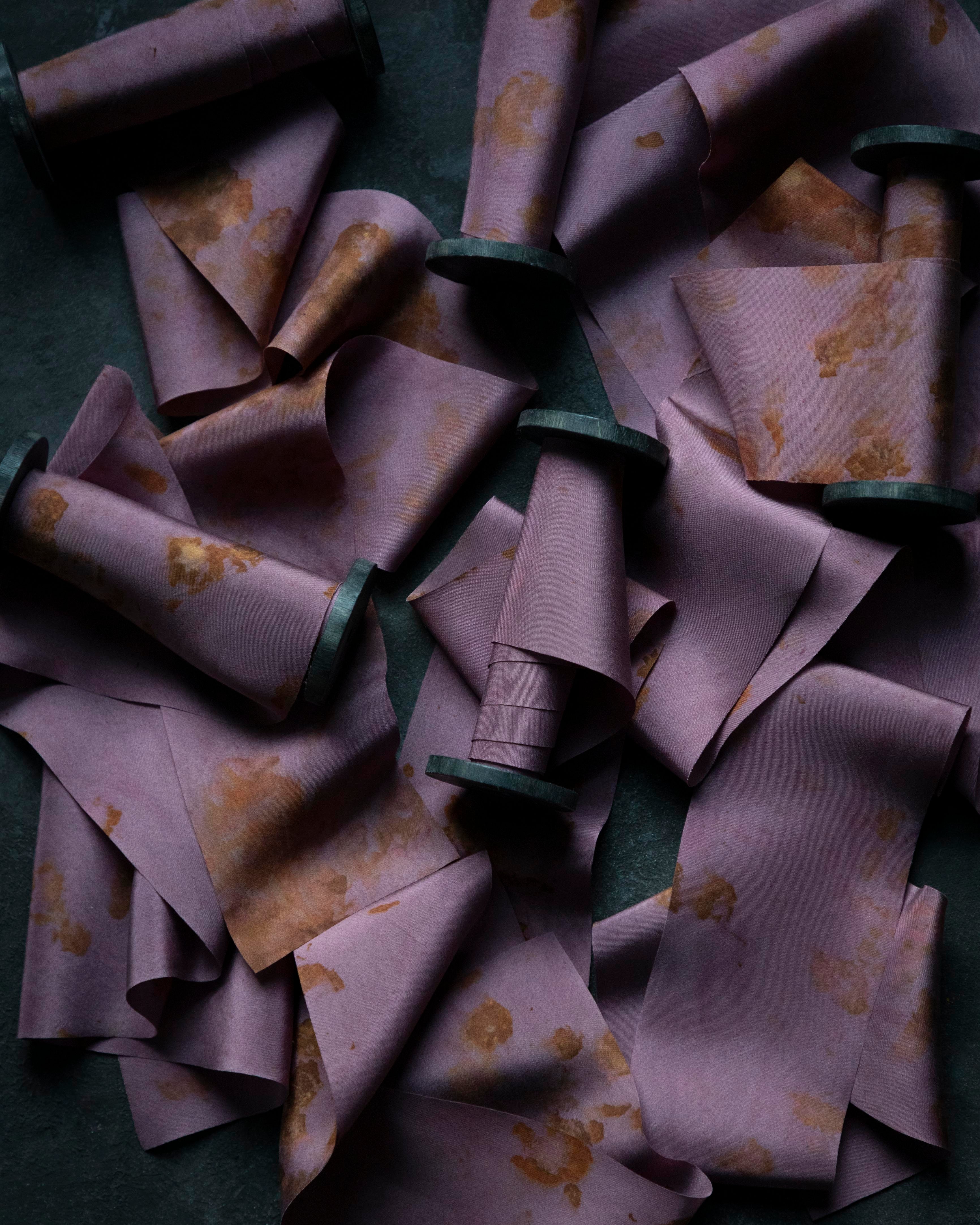 Purple fabric cones with floral patterns on a dark surface