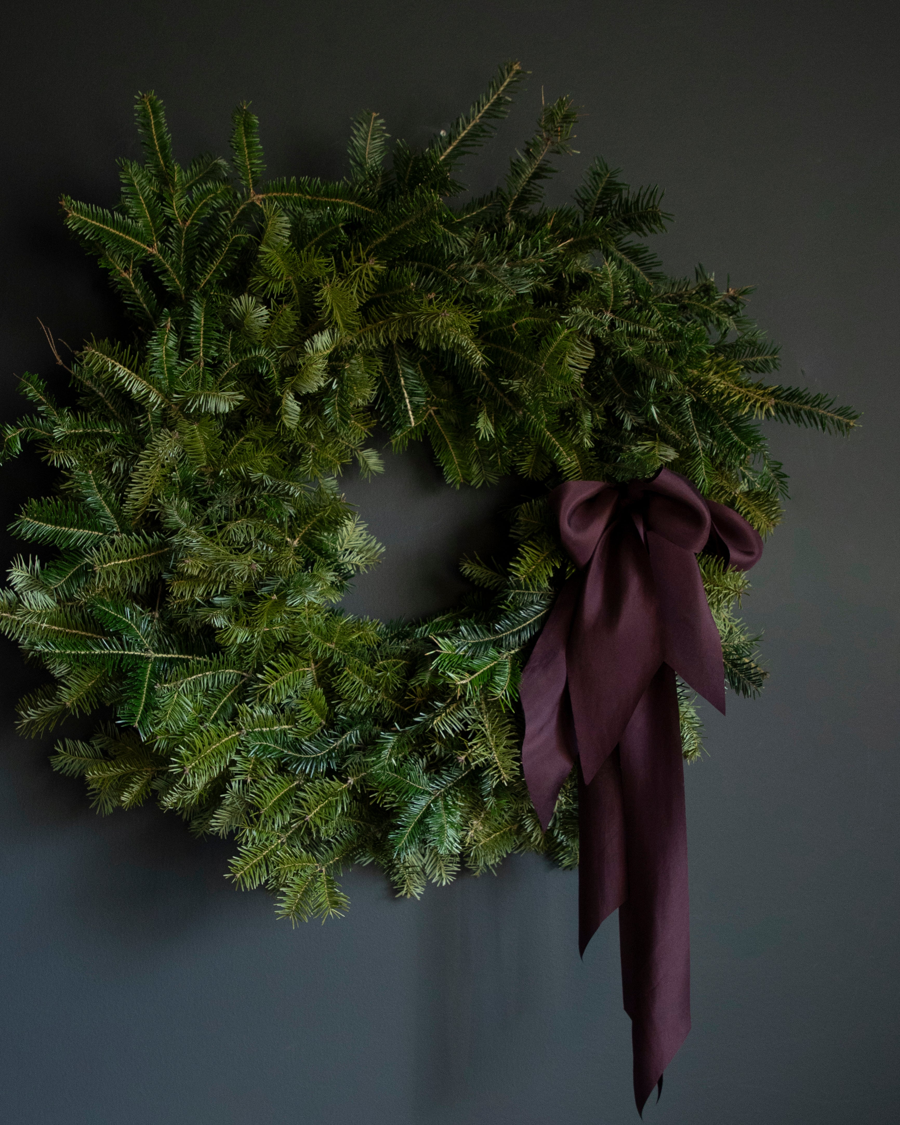 modern wreath design with plant dyed silk ribbons