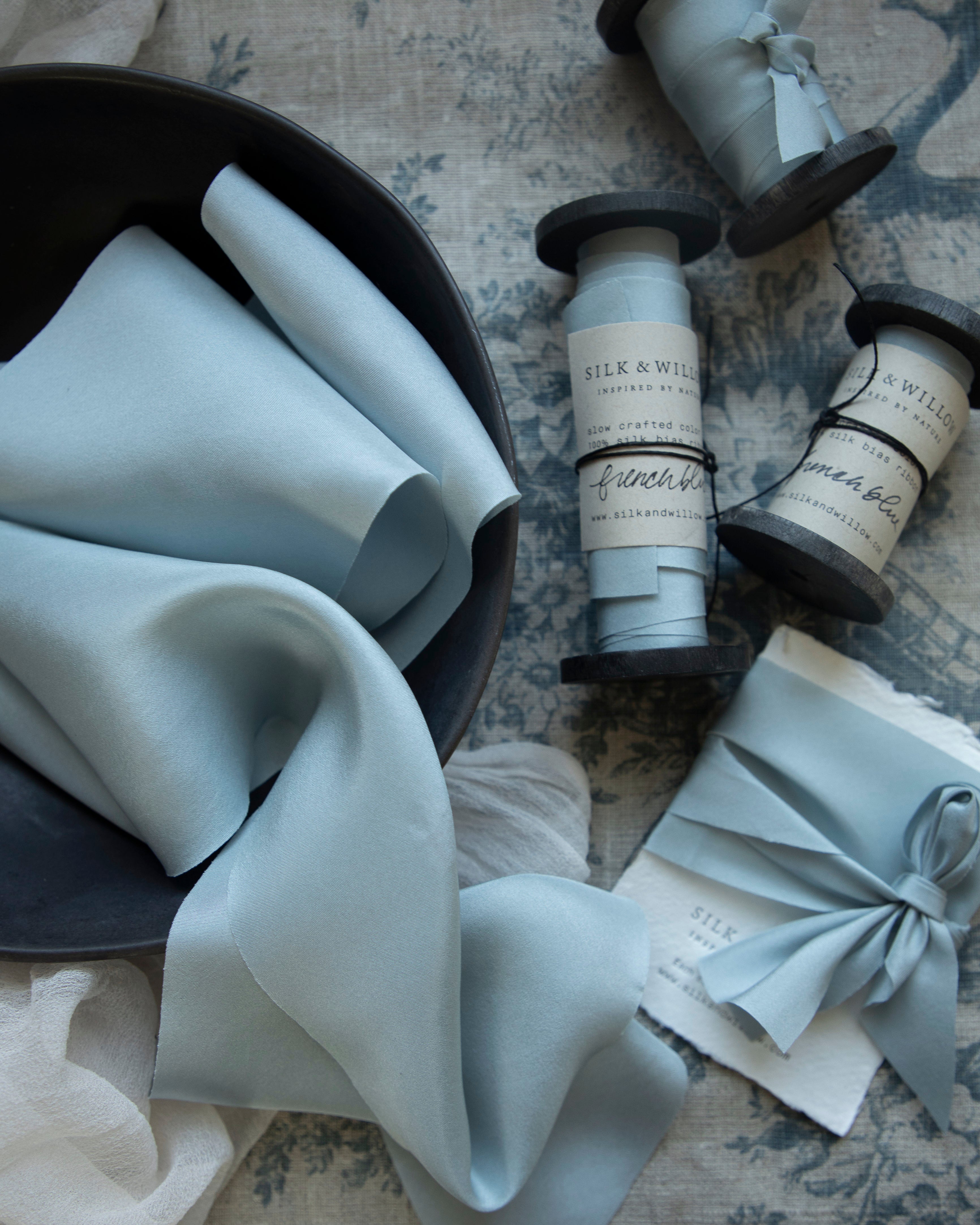 french blue silk ribbon on a vintage Italian linen background