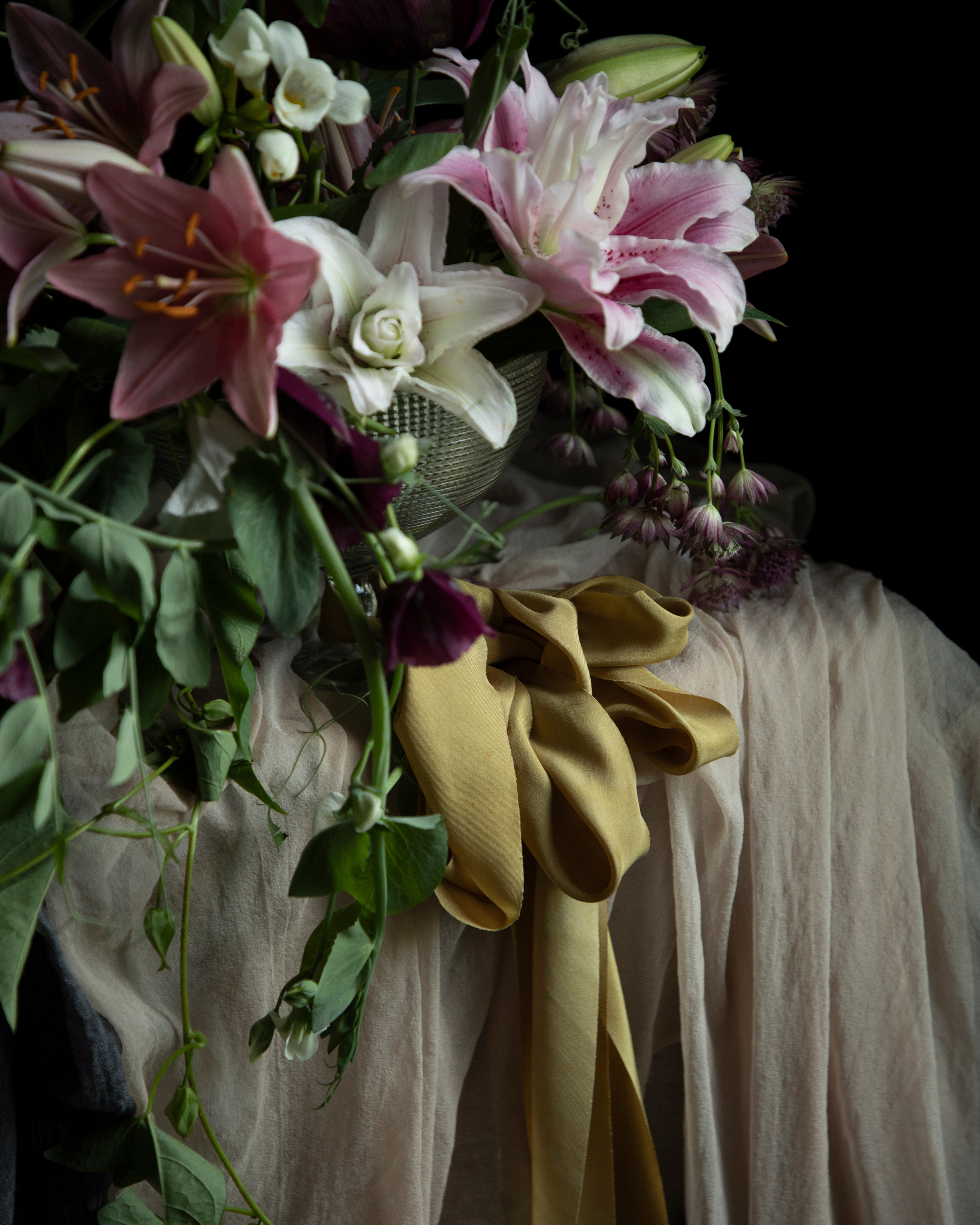 Bouquet of flowers with a yellow ribbon on a dark background
