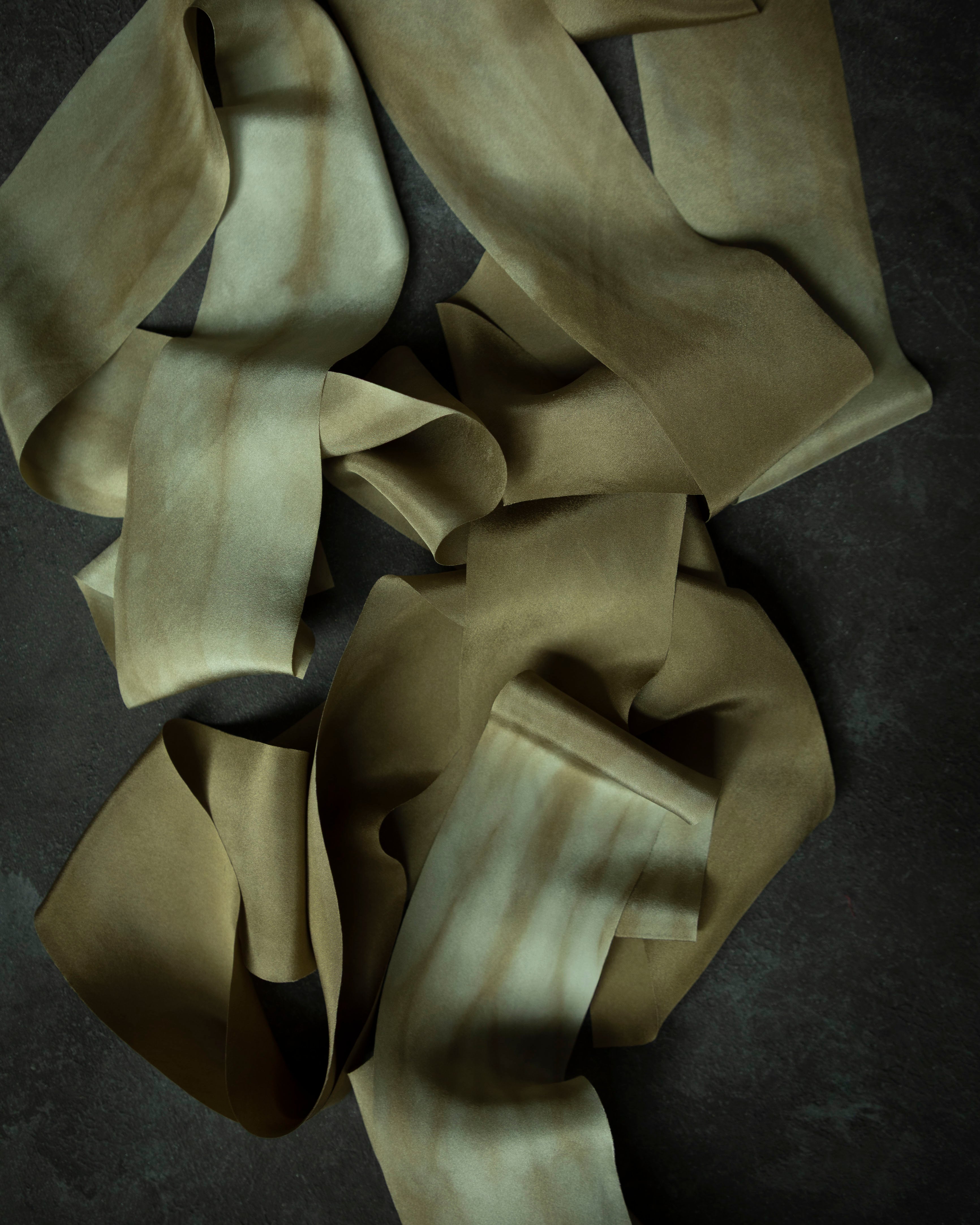hand dyed silk ribbons on a dark surface