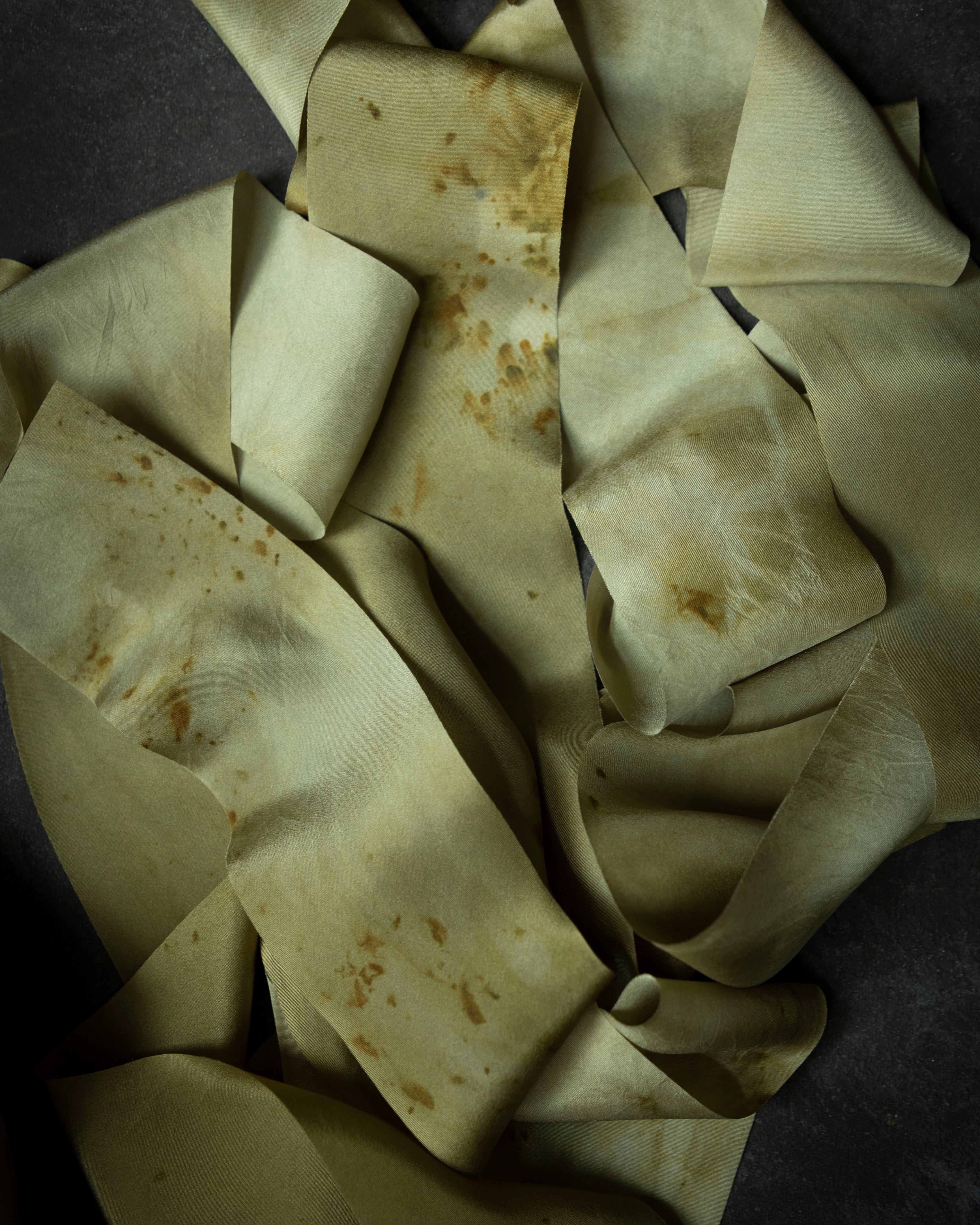 eco-print silk ribbons on dark background