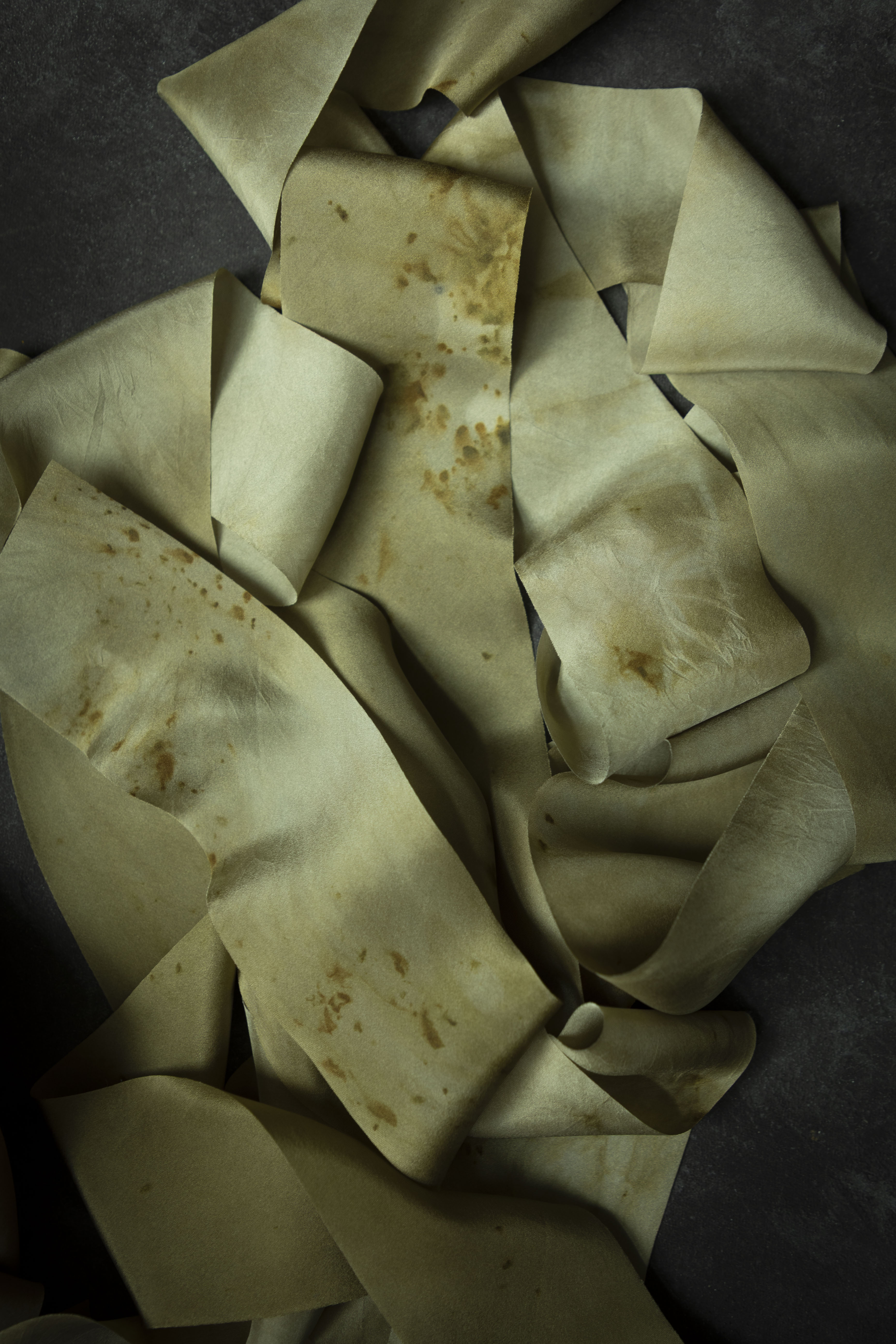 eco-print silk ribbons on dark background
