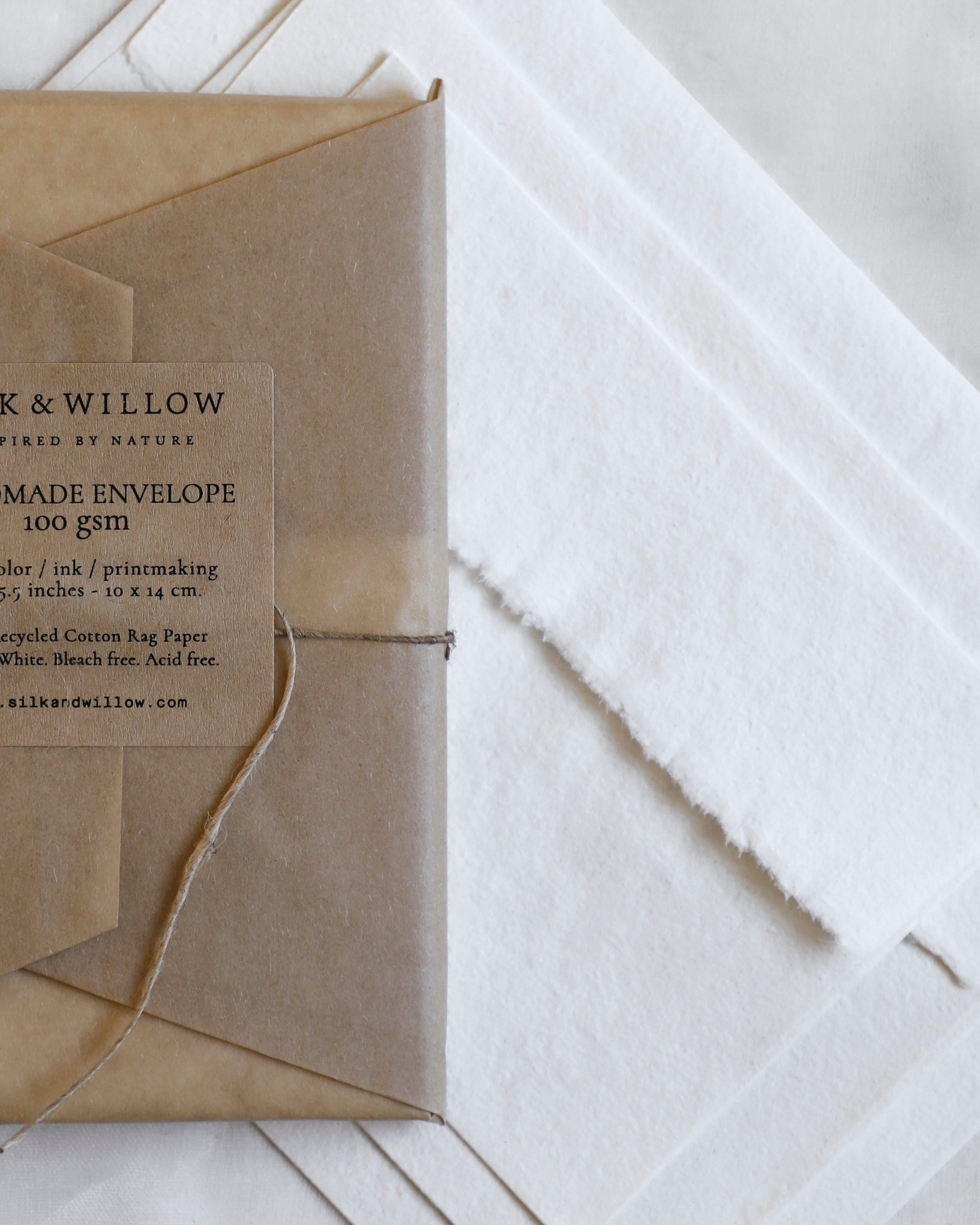 Handmade envelope with a label on a light wooden surface