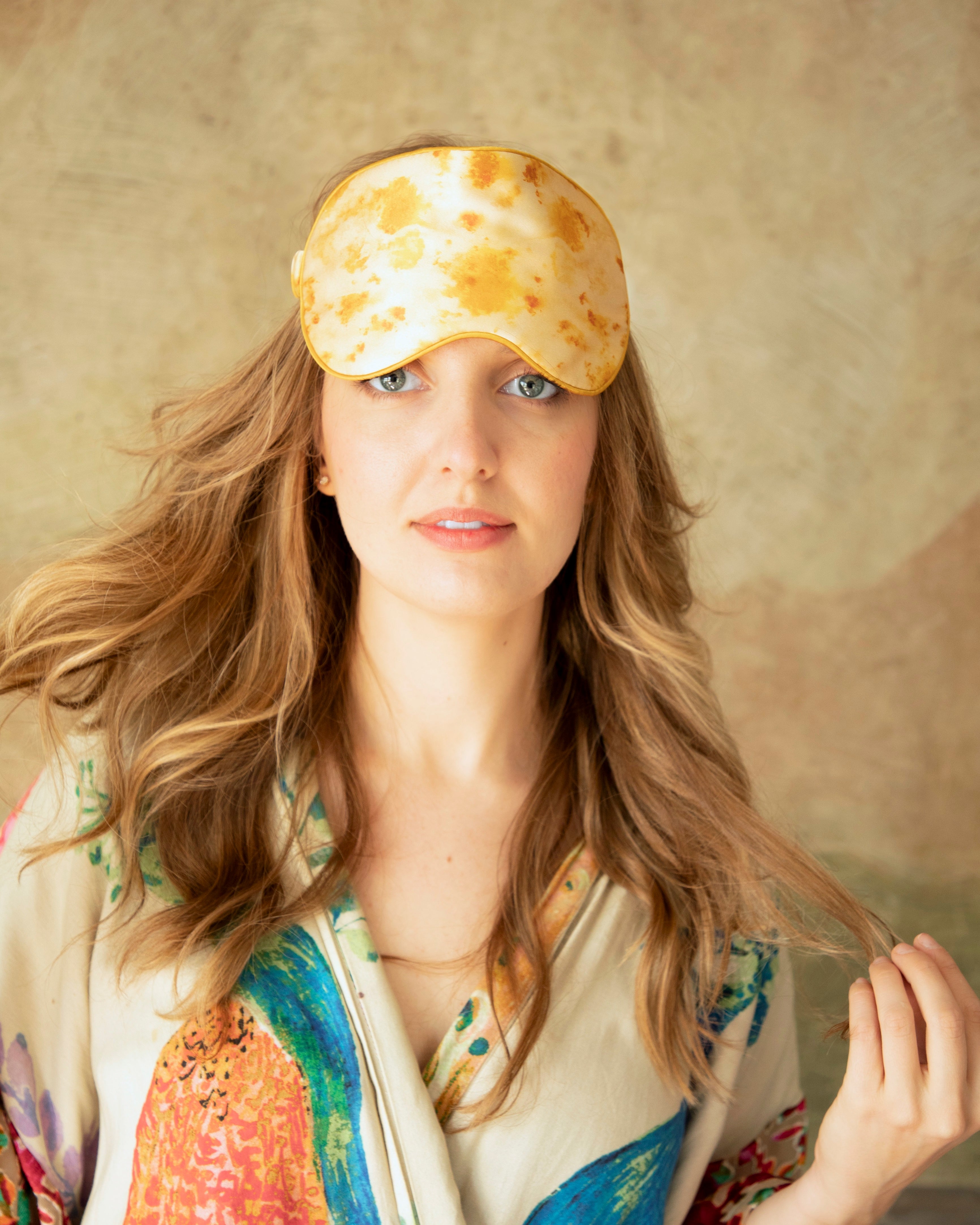 woman with long flowing hair wearing an anthropologie silk robe and a botanical print silk & Willow silk sleep eye mask