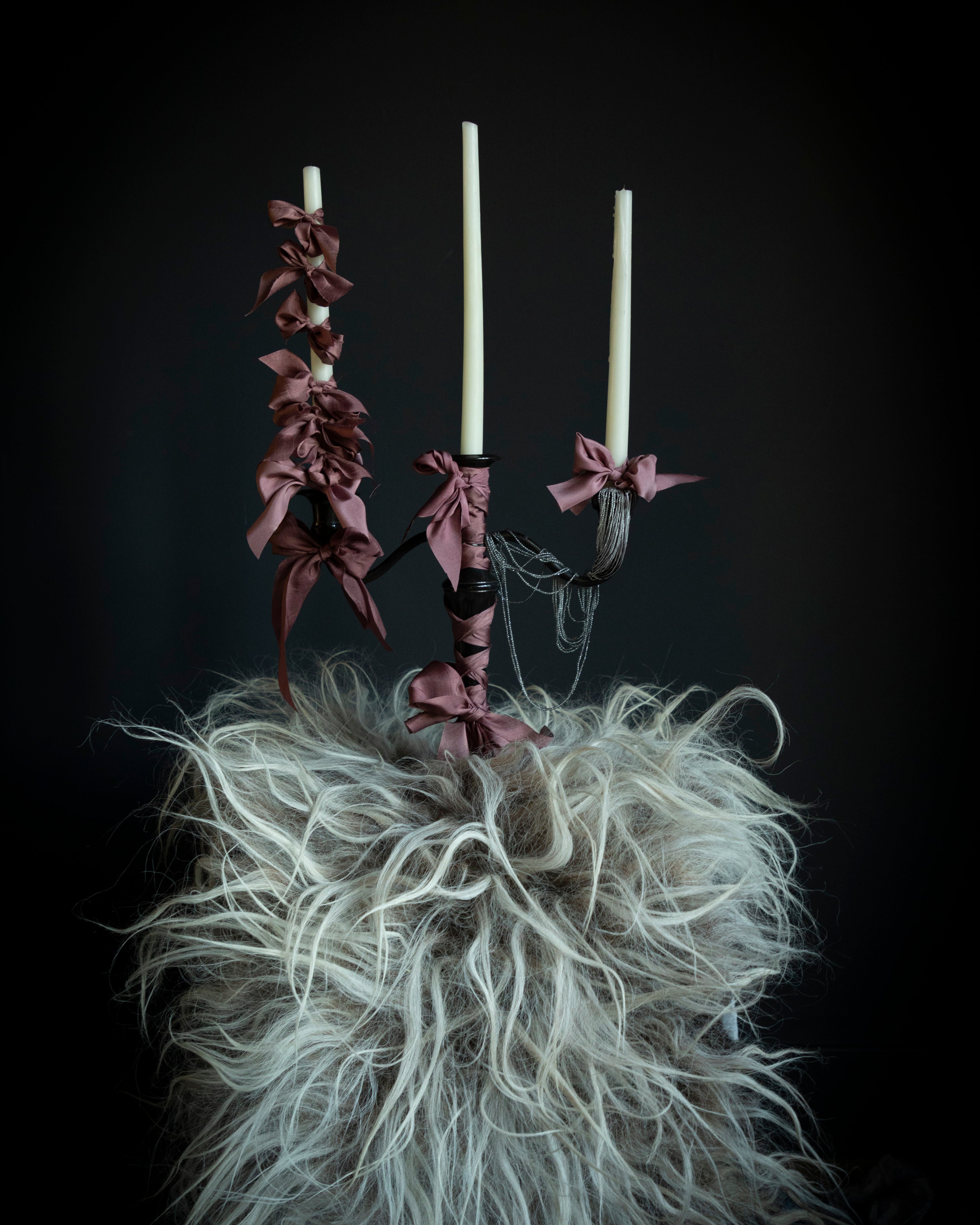 candles with silk ribbon bow. a moody room with viking style wedding inspiration