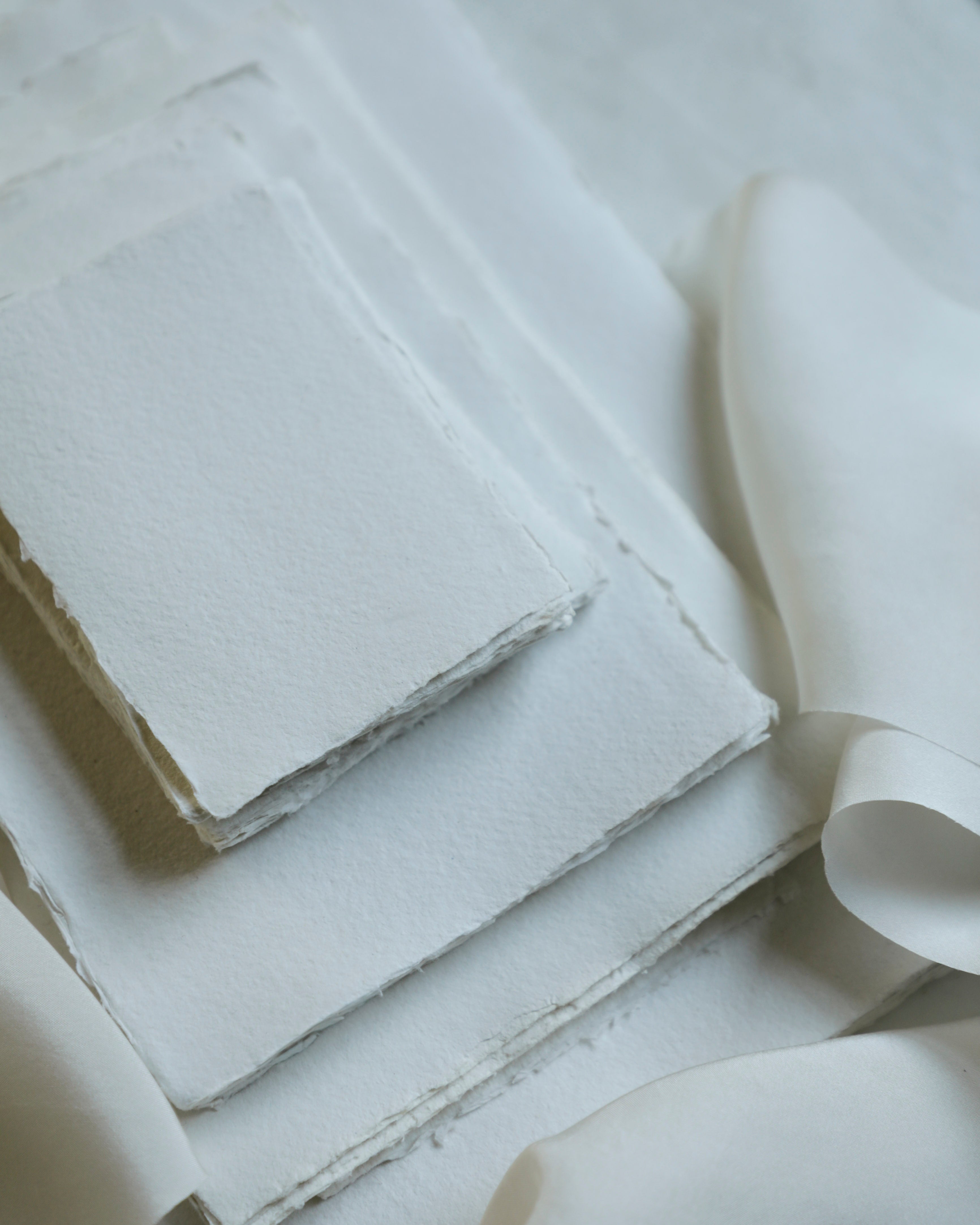 Stack of white paper sheets with a textured surface