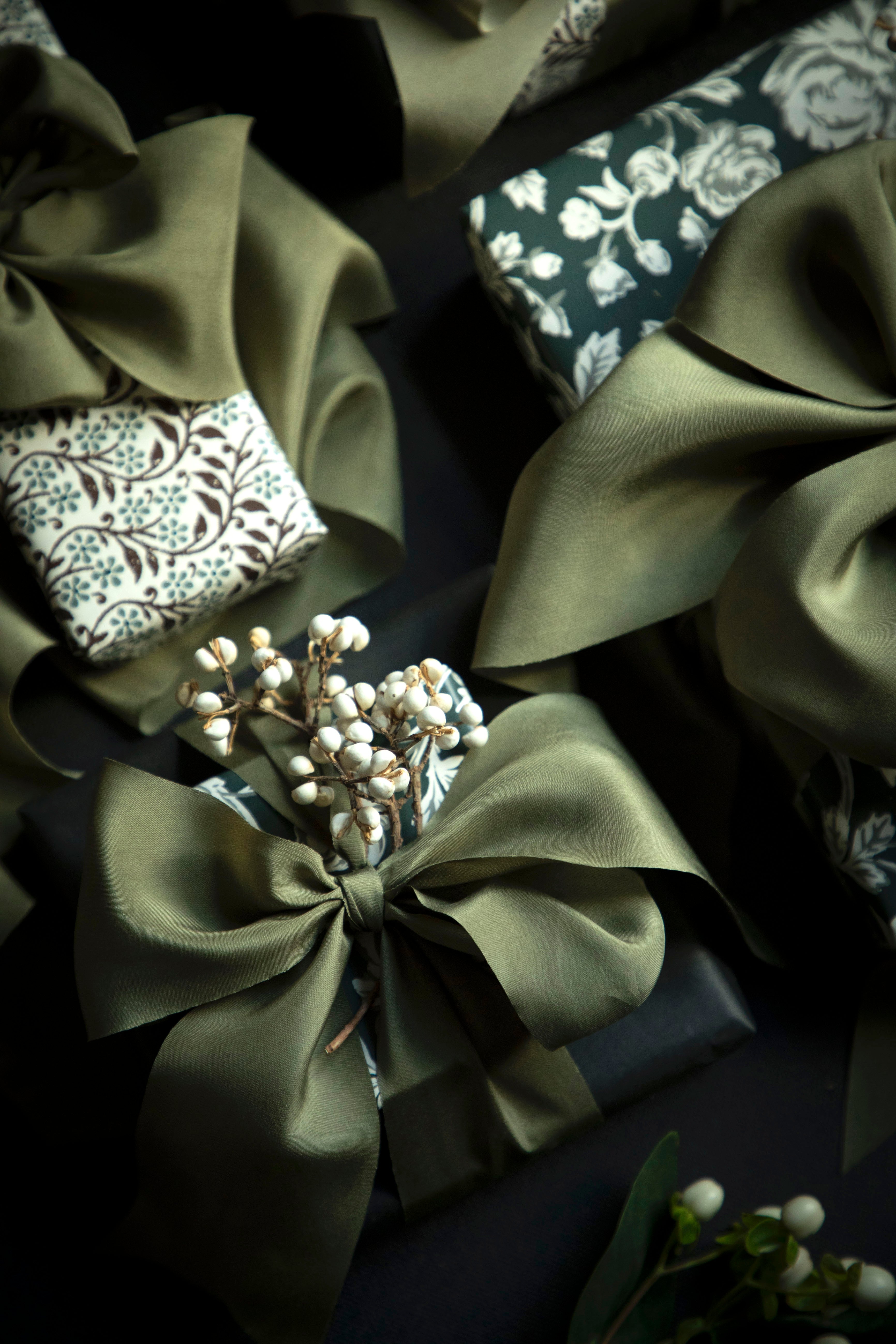 olive silk ribbon wrapped on studio McGee wrapping paper for christmas decor