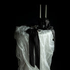 tablescape design. Wedding table with flowing white silk and black bow details