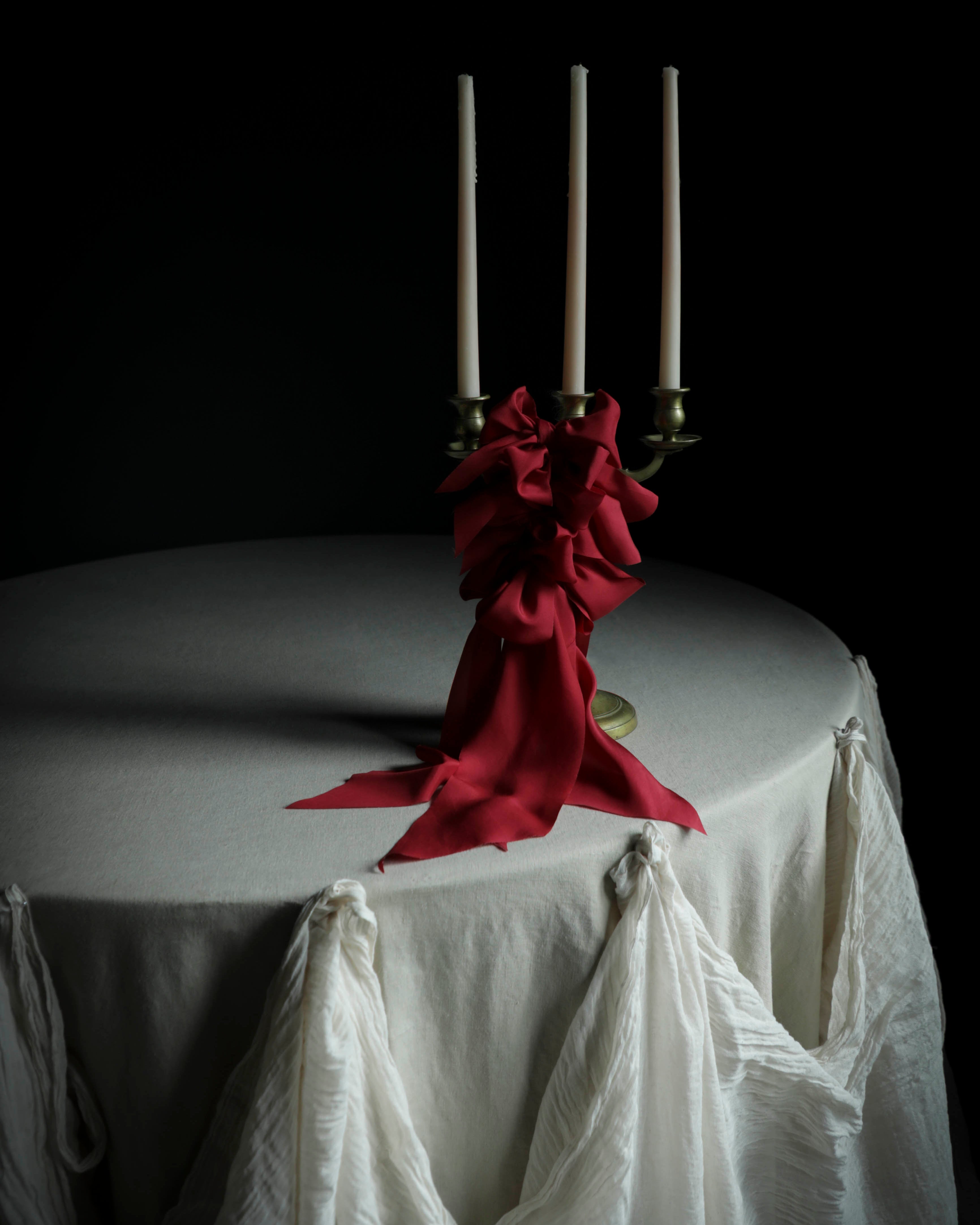 cherry red wedding decor candles red bows on white table