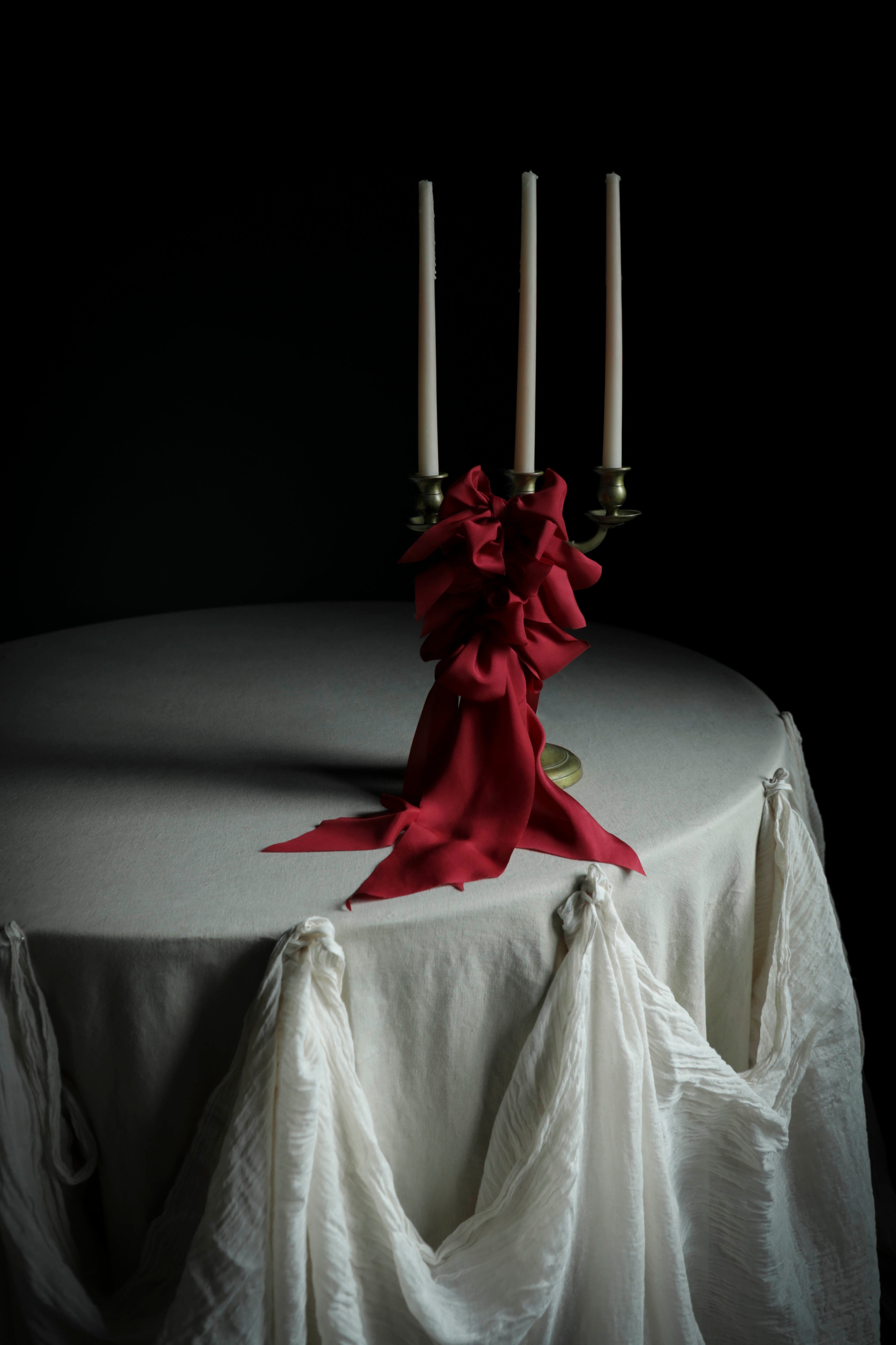 cherry red wedding decor candles red bows on white table