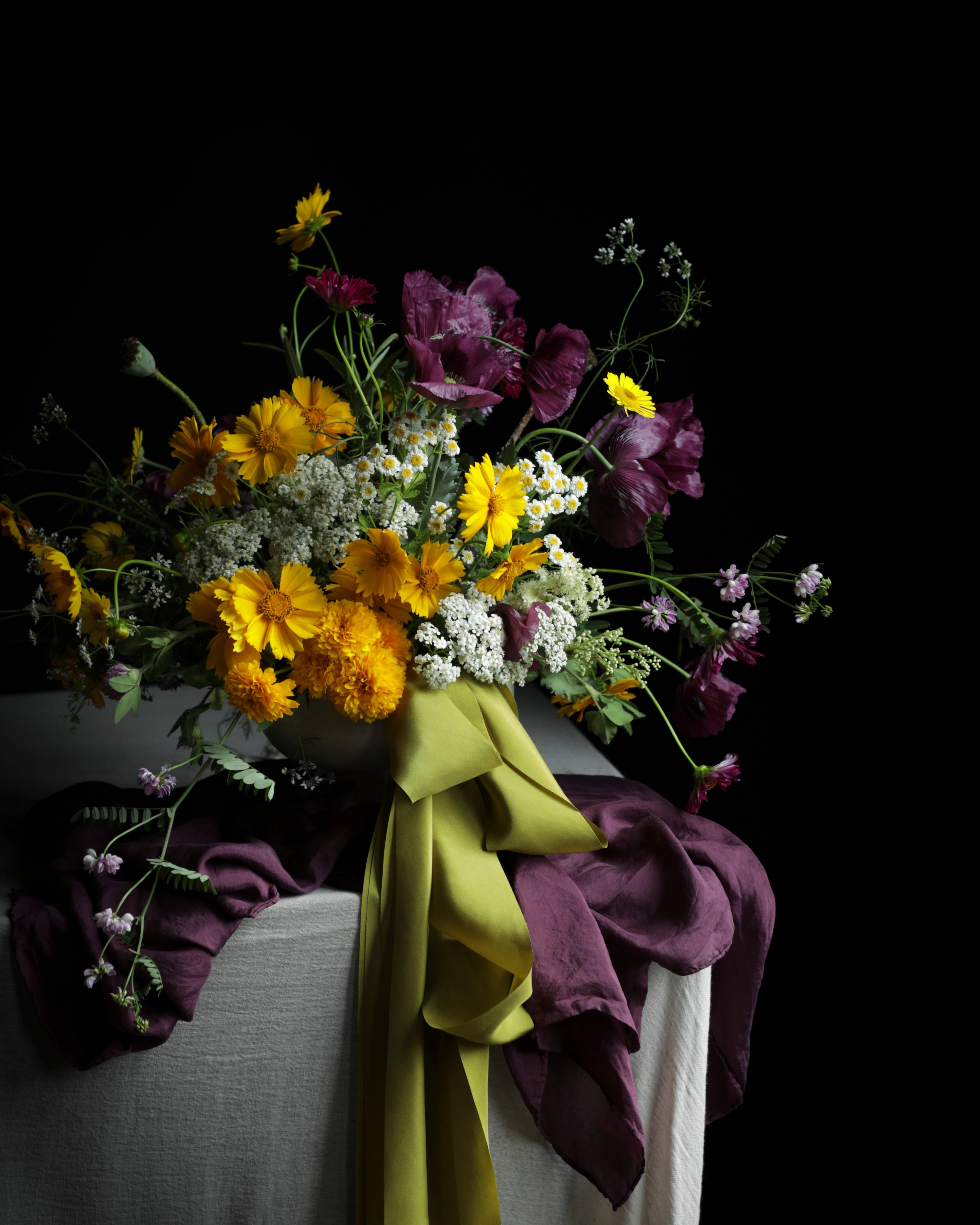 Bouquet of flowers with a green ribbon on a dark background